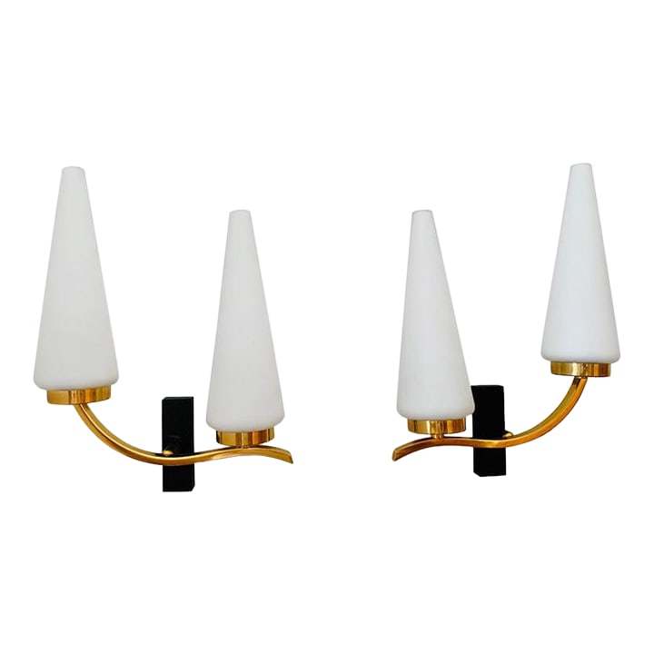 Pair of French 1950s Lunel Wall Lights: An excellent set of 1950s golden brass sconces composed of two light sources with matte white Opaline glass cone shades. Condition: Alterations: Restored Imperfections: Some Imperfections Condition