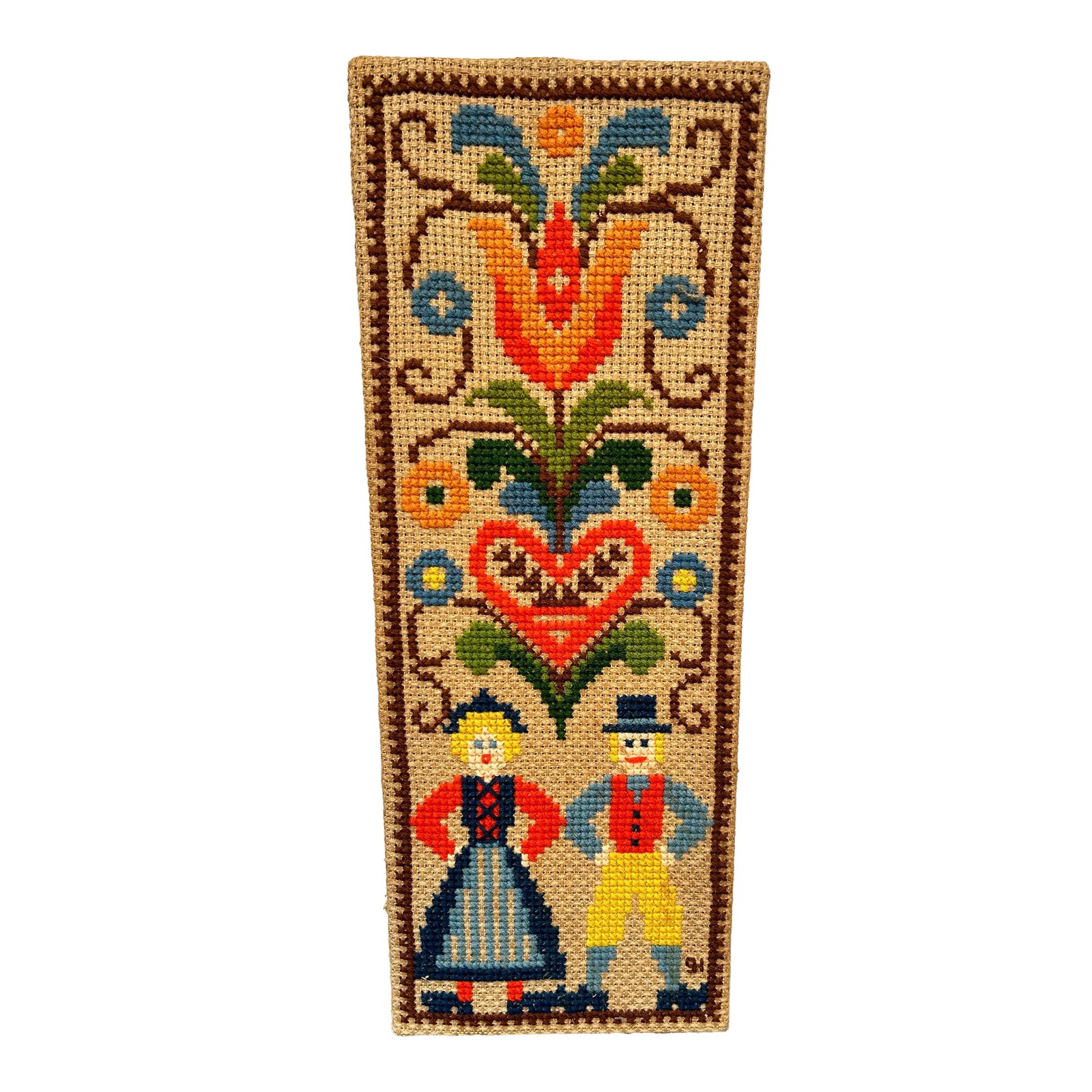 Mid 20th Century Scandinavian Folk Art Crewel Cross Stitch on Burlap: a fun crewel cross stitch on burlap art piece. This is a beautiful example of folk art in colors of red, yellow, green, blue, orange, and brown. There is a couple in native costume along with a lovely