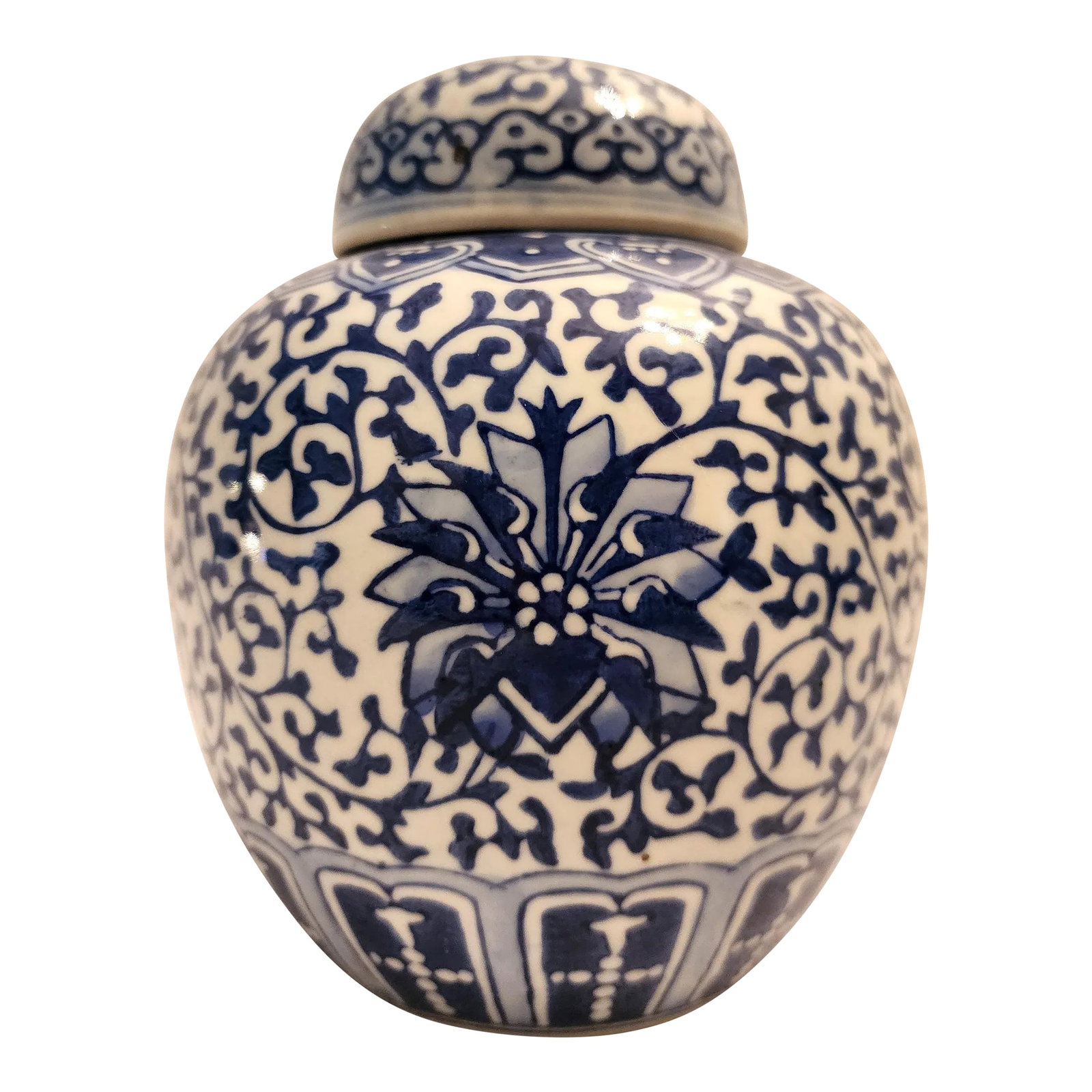 1980s Small Blue & White Ginger Jar With Floral and Vine Motif: A small porcelain ginger jar that pairs well with other blue and white collections adding interest and variation in height. 6.25"H x 5.25"D x 5.25"W. Condition: Alterations: Original Condition
