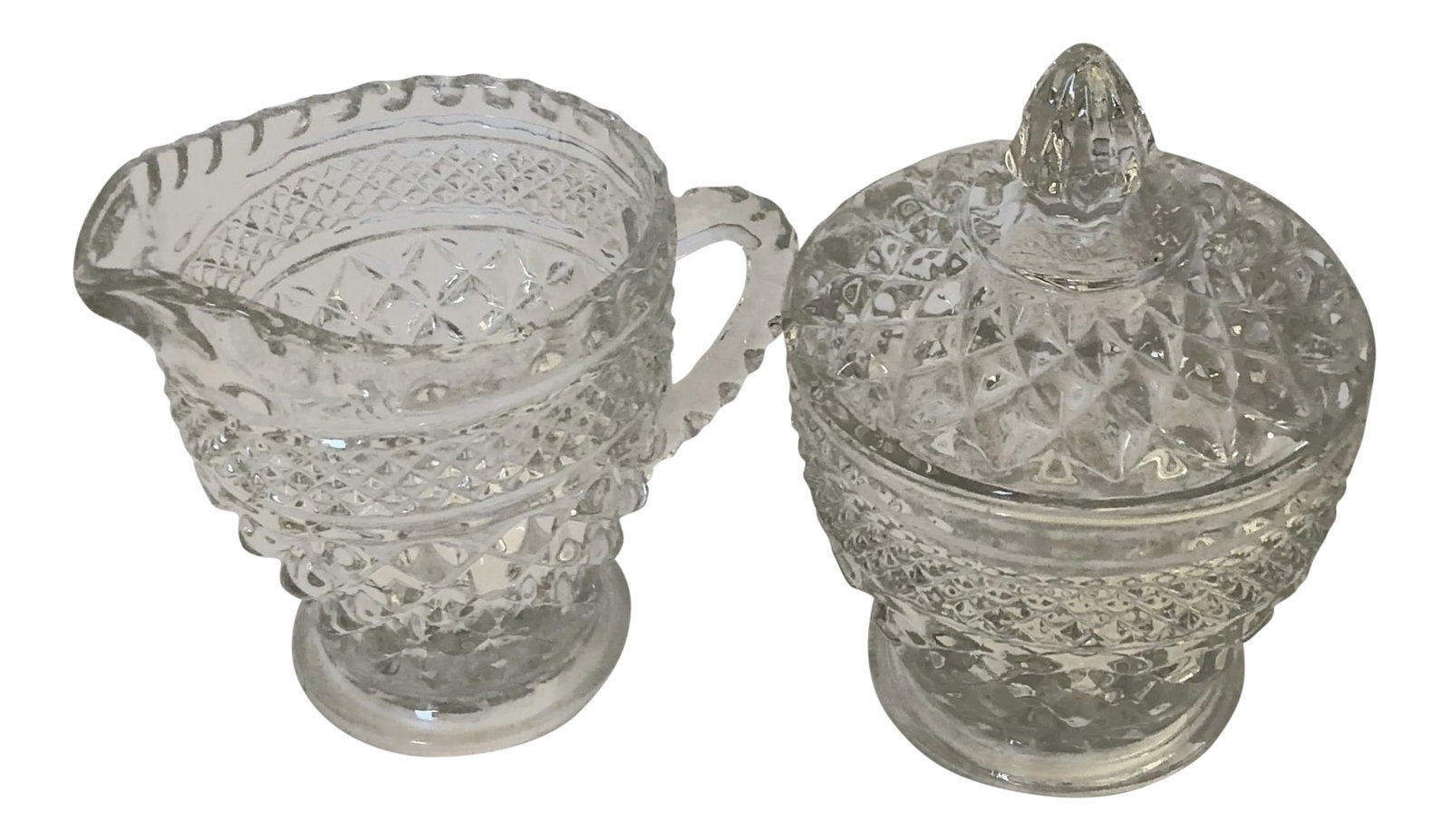 Vintage Clear Press Glass Sugar and Creamer Set: Vintage clear press glass creamer and lidded sugar set in excellent condition. Creamer is 4"H X 5"W Sugar is 3" H X 4" W Condition: Alterations: Original Condition Unaltered Imperfections: Some