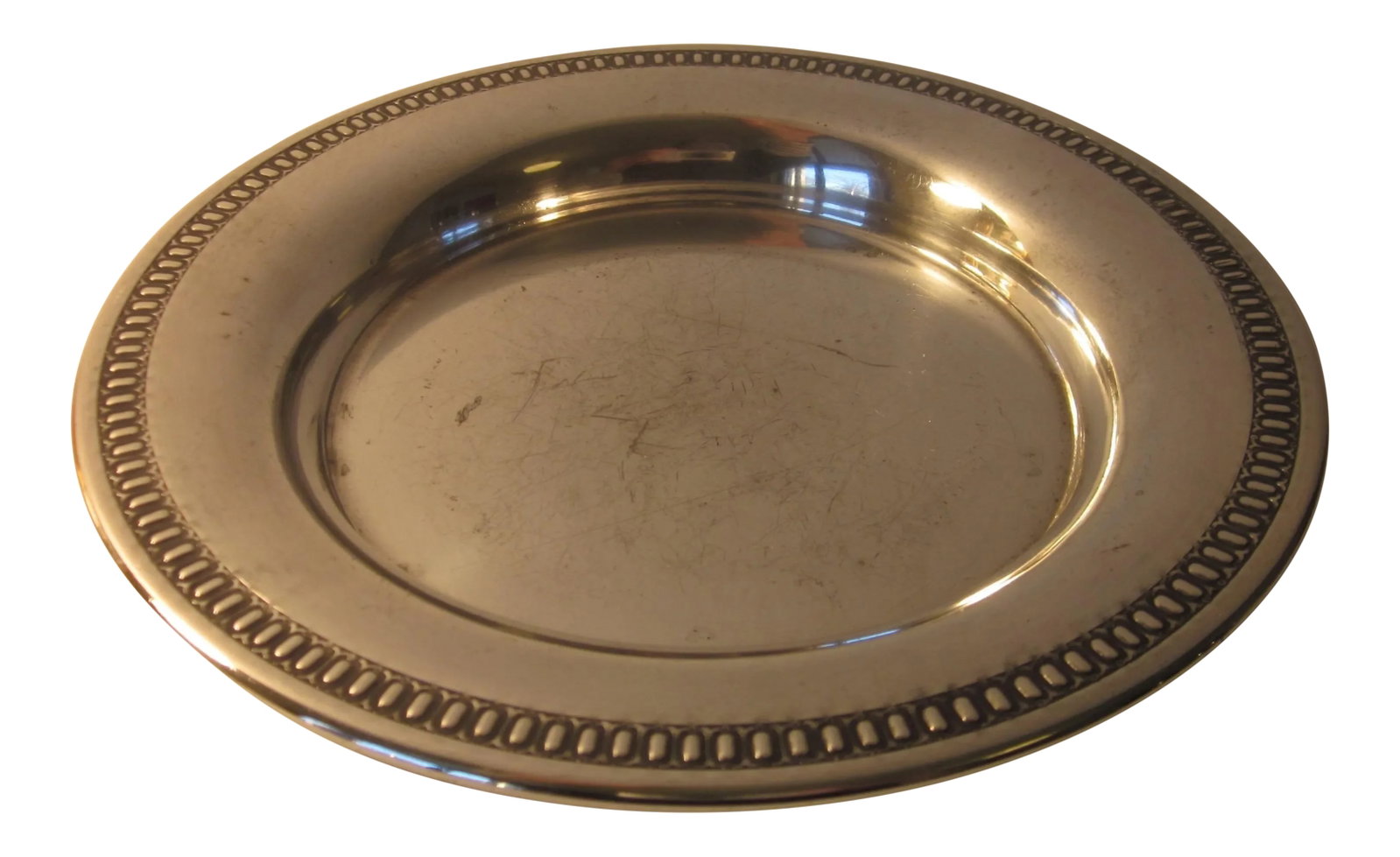 20th Century Traditional Silverplate Salver: A small silverplate salver or circular tray with handsome beaded rim, measuring 6.25" diameter and .75" deep. Marked "Wm Rogers / Hamilton, Can / E.P. on copper / 69-42. Visible age and wear gives it 