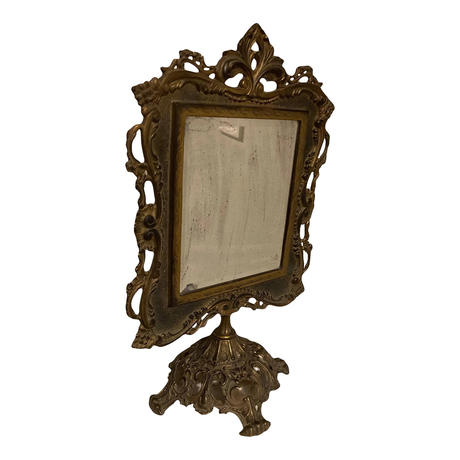 19th Century Ornate Brass Tabletop Mirror on Stand by National Brass and Iron Works: A richly patinated and ornate brass tabletop mirror on stand, dating approximately from the late Victorian Era (late 19th to early 20th Century). Retaining the original mirror and backing. Mirrored