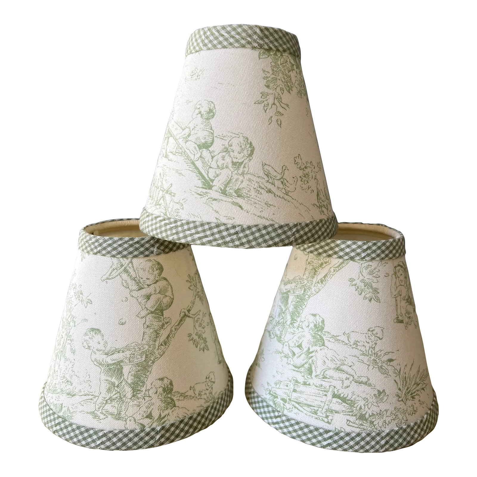 Set of 3 Green Toile Clip on Lamp Shades for Chandeliers or Sconces With Gingham Trim: This very pretty set of 3 lamp shades will enhance the charm of a sconce or chandelier. Featuring cherubic children playing in the garden, the shades are a beautiful green tone with ivory. The