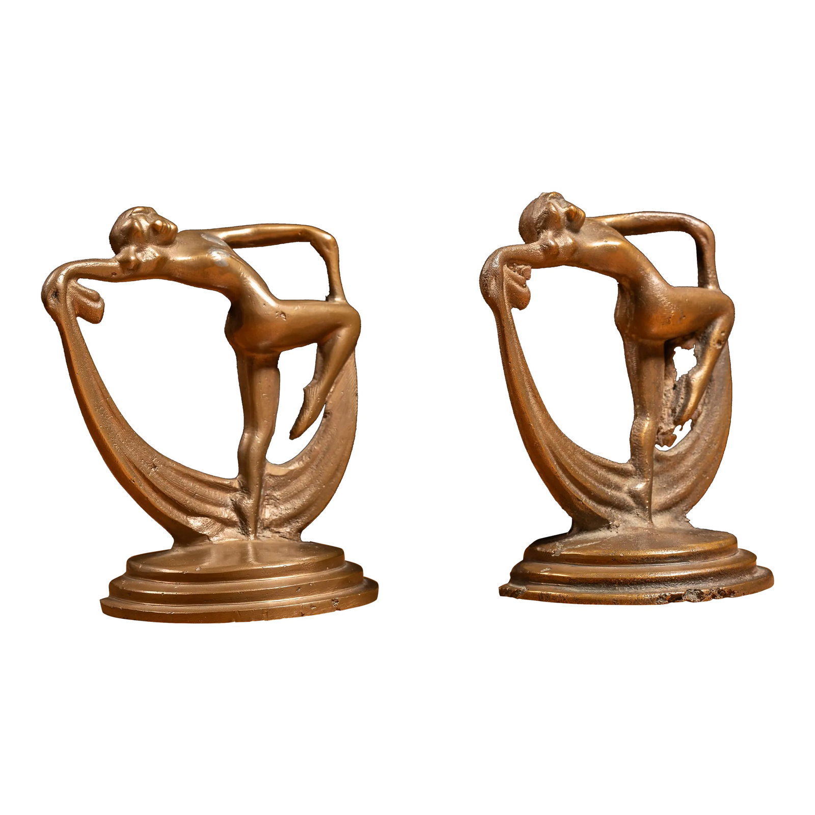 1920s Cast Brass Art Deco Scarf Dancer Bookends- Set of 2: c. 1930s brass bookends designed after the art of Max Le Verrier. Each of these identical pieces feature the figural form of a nude female scarf dancer atop a circular streamline base. These pieces fe