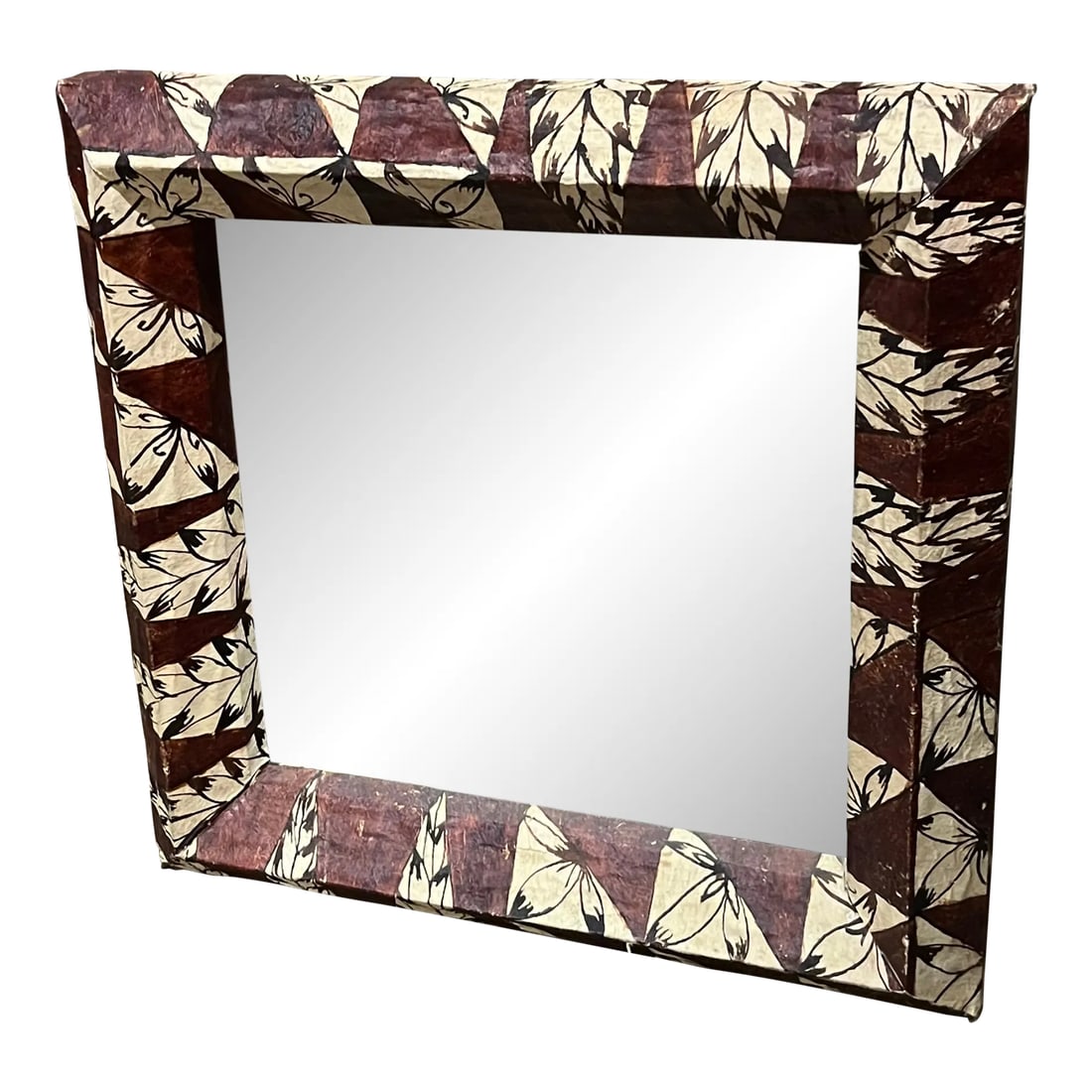 1950s Mirror Framed in Tonga Tapa Cloth: Bark Cloth, or tapa, is not a woven material, but made from bark that has been softened through a process of soaking and beating. The inner bark is taken from several types of trees or shrubs, often