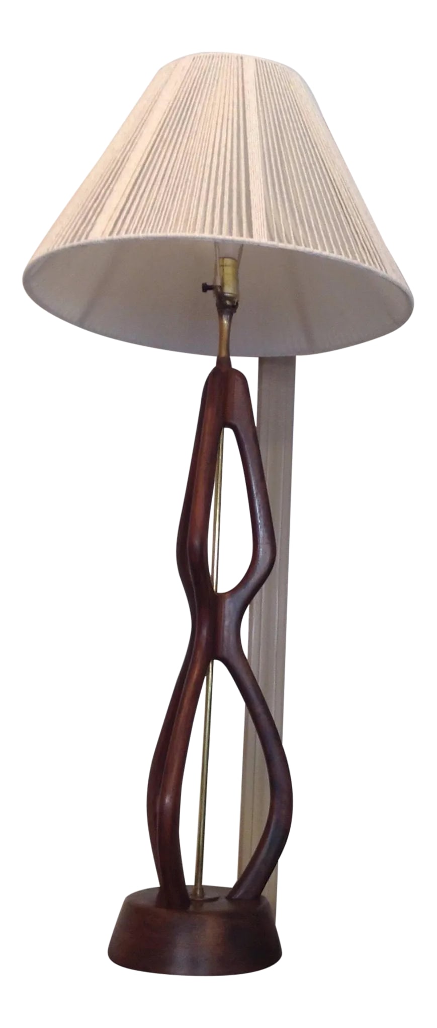Mid Century Modern Oversize Sculpted Walnut Table Lamp With String Shade 60s: Elegant extra tall sculptural Walnut table lamp of Danish Modern Design. Brass center shaft. Round solid walnut base. Comes with string shade. In good vintage condition with patina on the brass,