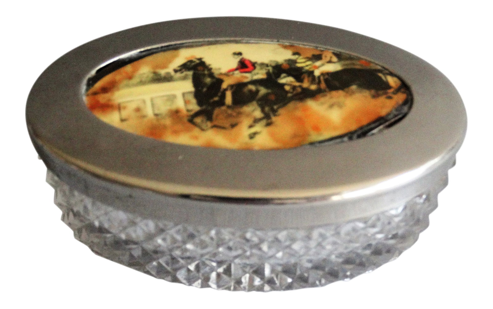 Vintage English Equestrian Trinket Box: An early 20th-Century English crystal and silver-plate box with an equestrian scene. The lid depicts 2 riders and horses in a race. It is perfect as a desk accessory for paperclips, coins and small