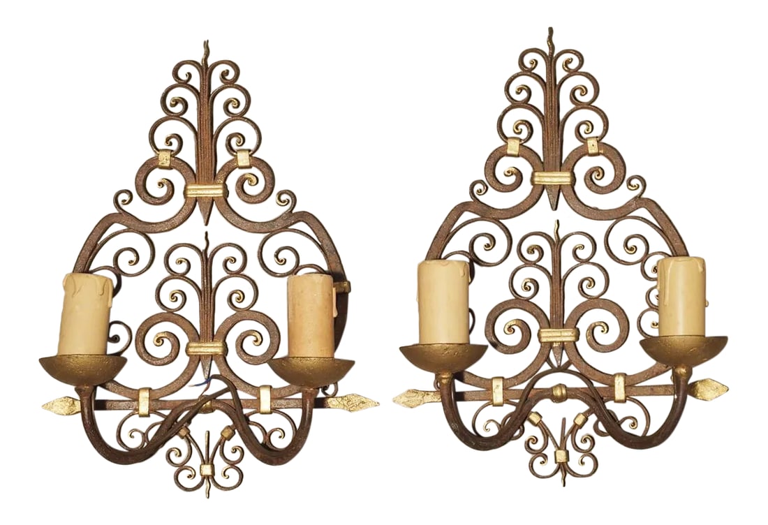 1940s Wrought Iron French Sconces With Gilt Highlights, 1940s - a Pair: This highly detailed pair of two arm, French wrought iron sconces have been given gilt highlights. They date to the 1940' and their motifs include several series of C-scrolls. The backs are narrow at