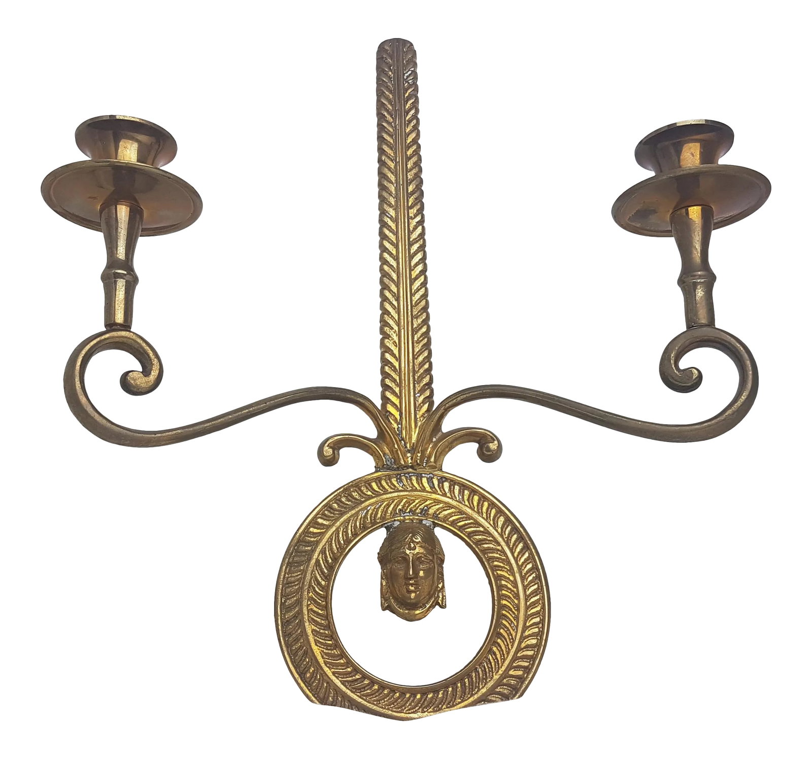 Vintage 1990s Brass Two-Light Wall Sconce: This classical style brass sconce can hold two taper candles. Made in India, it features a beautiful patina and a round bottom focal point incorporating a head/figure in the middle. There are also