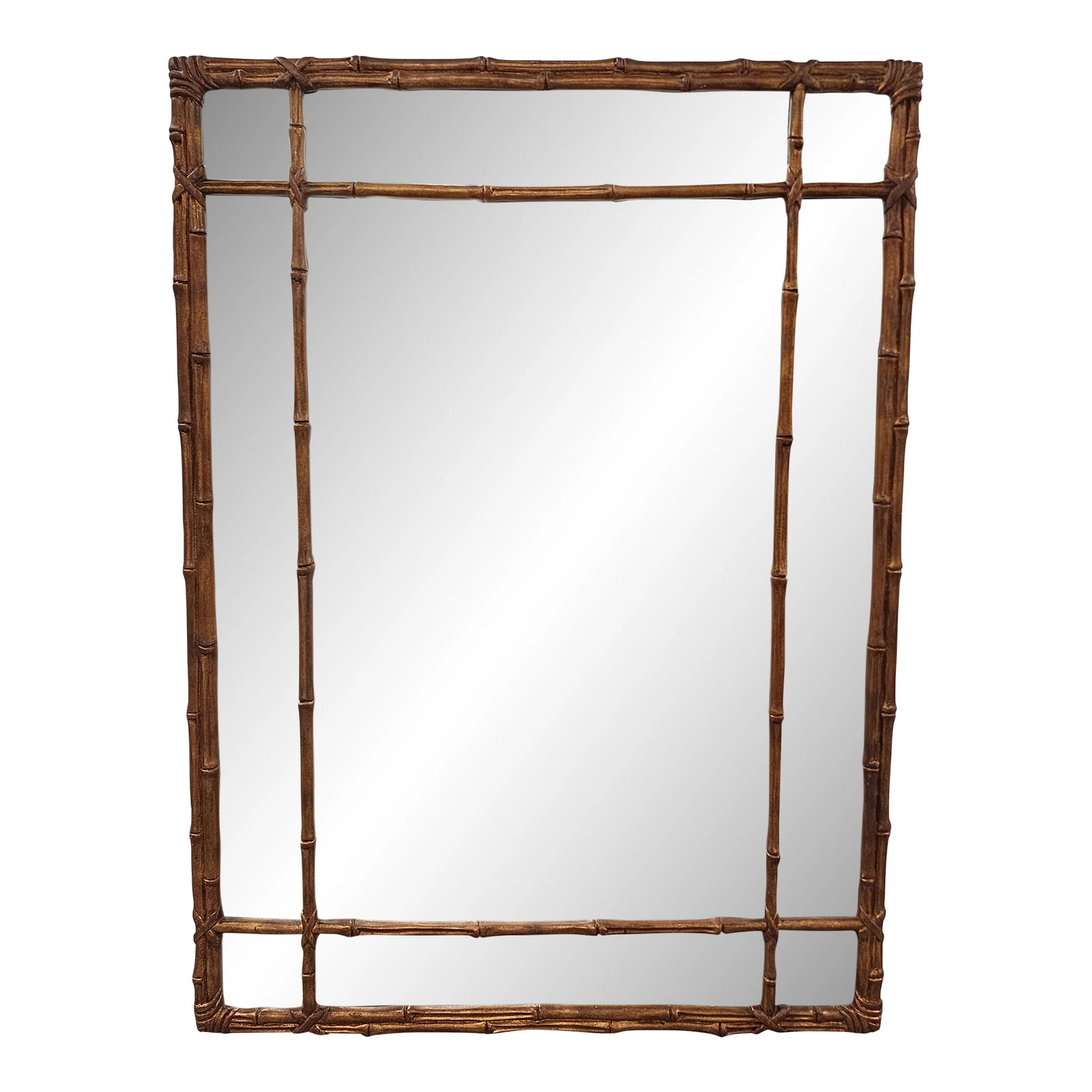 Vintage Hollywood Regency Style Gilt Faux Bamboo Mirror: Large Hollywood regency style faux bamboo mirro, featuring a detailed double fret panel, in a gilt bronze finish. The mirror is surrounded with wooden panels exhibiting a bamboo-style design. With
