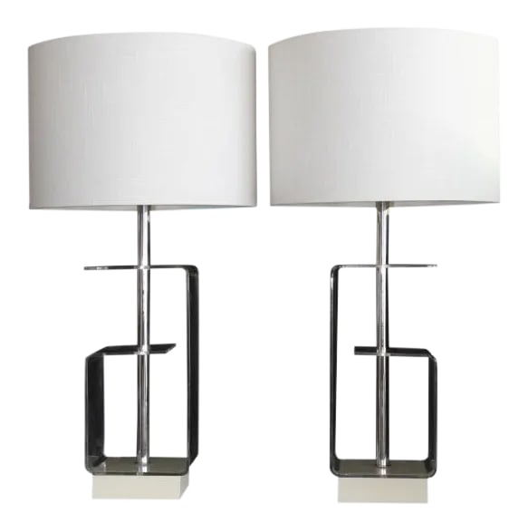 Geometric Clear Lucite Table Lamps - a Pair: A beautiful Pair of geometric Lucite table lamps.The shaping of the Lucite give these lamps an unusual look. Mounted on enameled wood. Light and airy,Visually they are sculptural. The epitome of the
