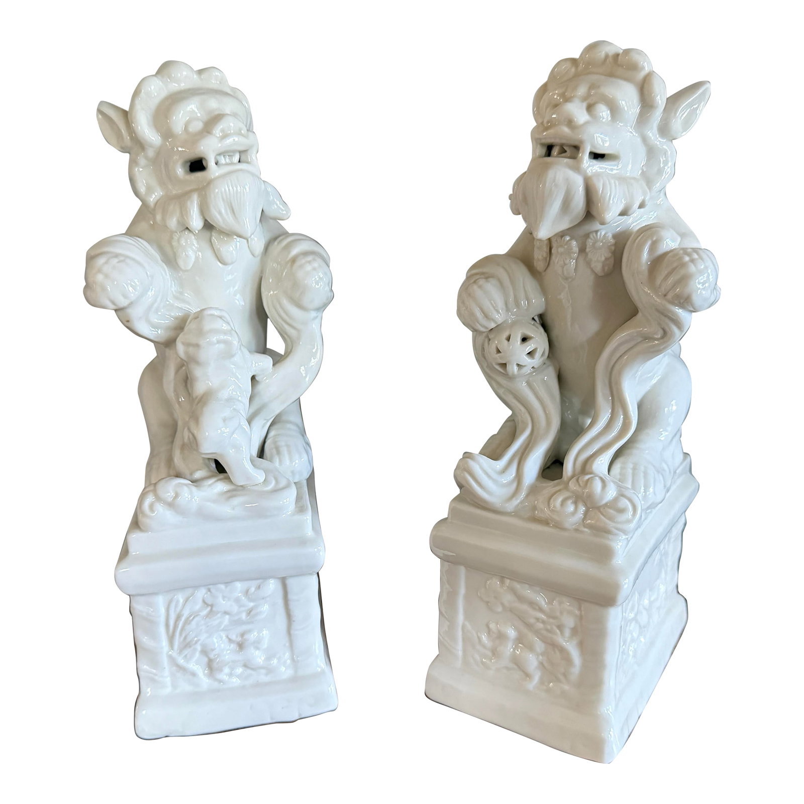 Blanc De Chine Foo Dogs With Ball and Baby, 1940's, a Pair: These foo dogs are a beautiful white porcelain and in excellent vintage condition. They are sure to add classic charm to any room in your home. The male is holding a ball representing protection for t
