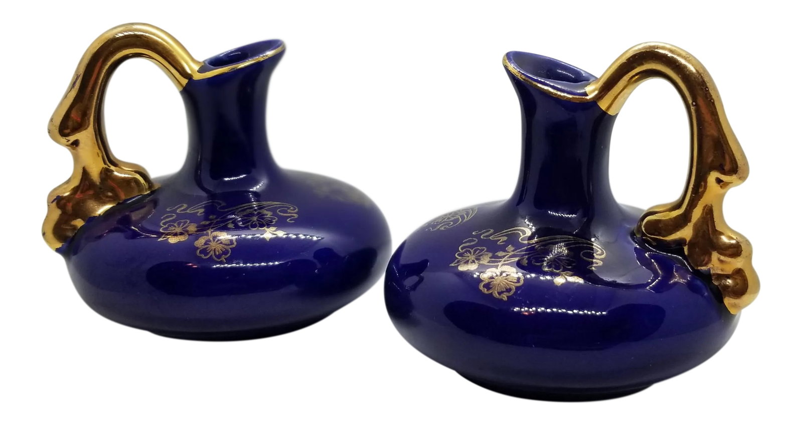 Art Deco Dark Blue Porcelain Pitcher Cruets with 22k Gold Hand Painted Trim - a Pair: We love this extraordinary set miniature cruet pitchers for there beautiful dark blue porcelain finish with stunning hand painted designs and handles in 22K gold paint with early 1900's styling. Condi