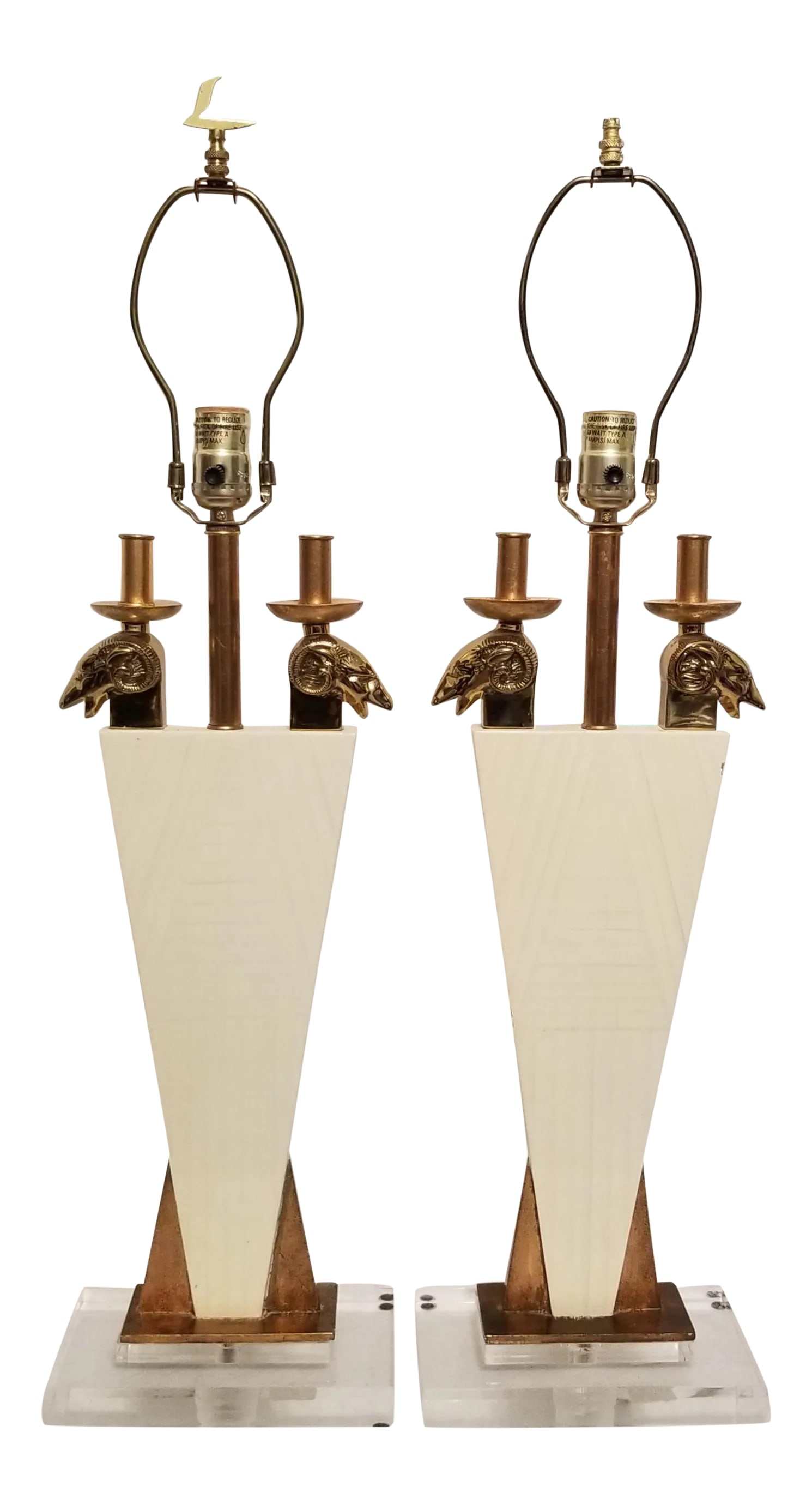 1970s Leeazanne Lamps Ivory With Brass Rams Heads Lucite Base for Lee Lam - a Pair: We love this extraordinary pair of Leeazanne table lamps for their outrageously unique geometric 1970's style. There are two brass rams heads on each lamp that extend into brass faux candle holderss,