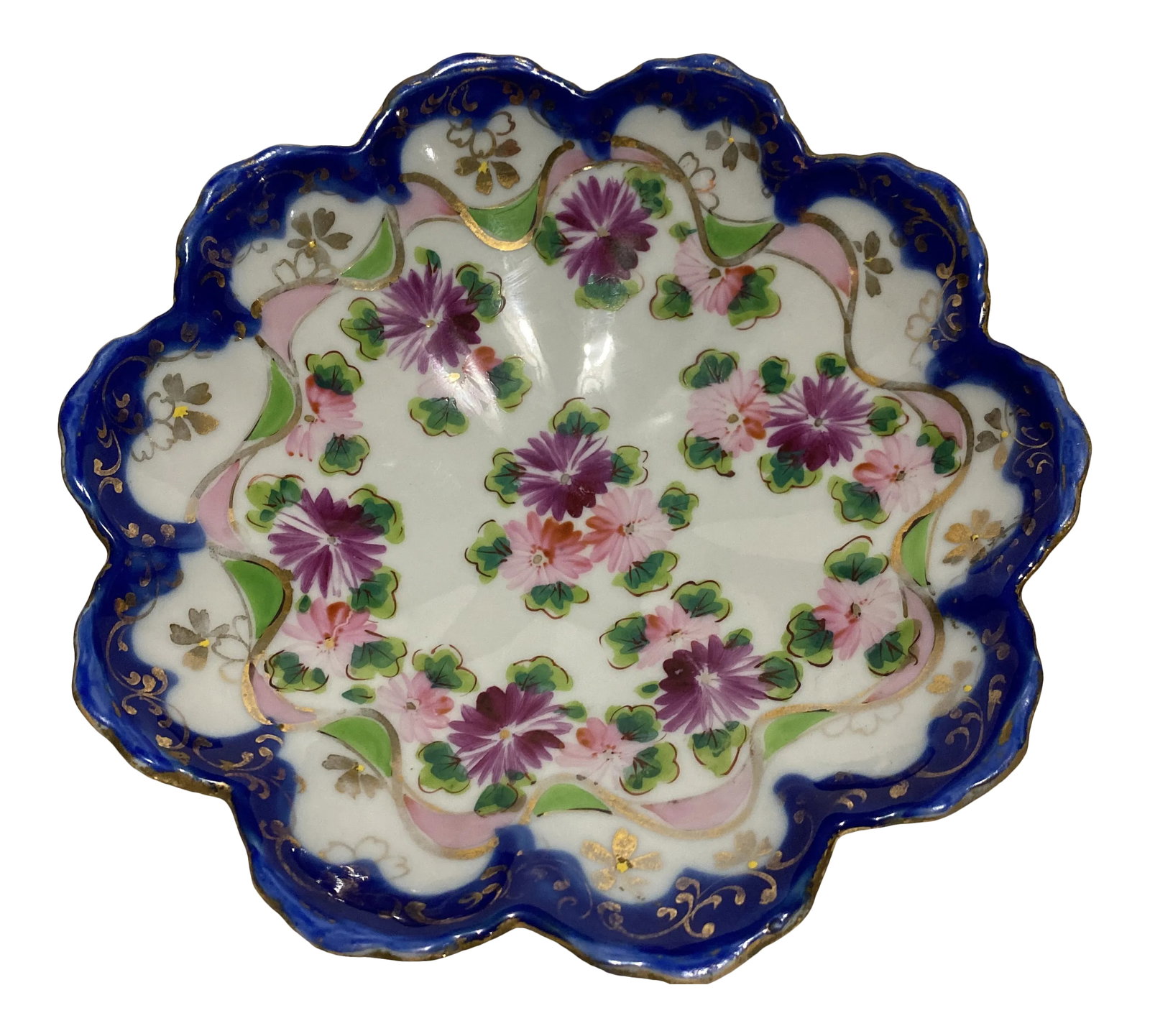Antique Flow Blue Hand Painted Ironstone Footed Scallop Bowl: Flow blue china bowl with handpainted decoration, featuring a ribbon, clover, and asters. Scalloped form on 3 scrolled feet. Condition: Alterations: Original Condition Unaltered Imperfections: Some