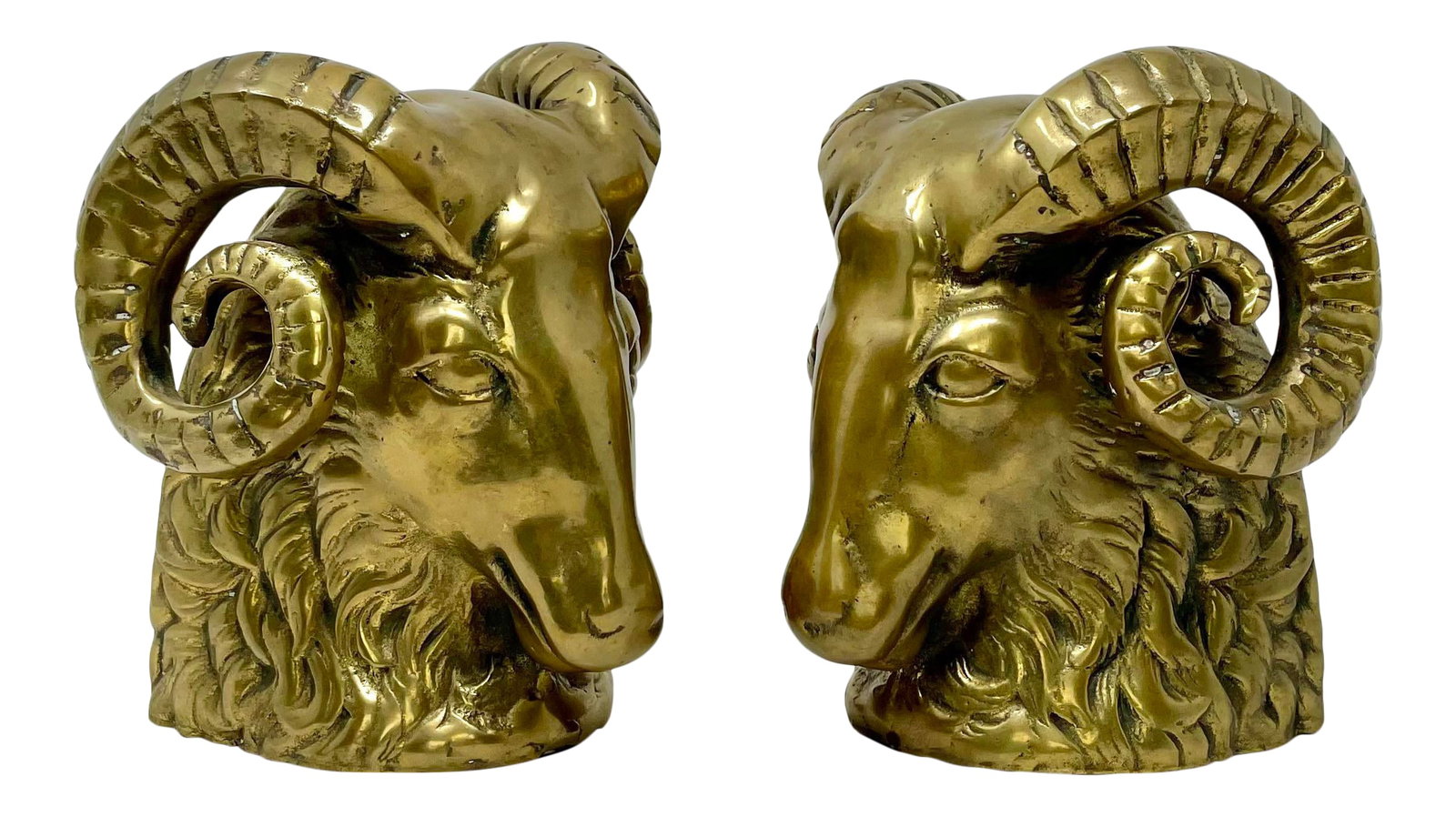 Vintage Hollywood Regency Brass Rams Head Bookends - Set of 2: An outstanding set of vintage brass Rams head bookends, c.1960's. Highly detailed, solid and heavy weighted. Beautiful lite-even age patina. Condition: Alterations: Original Condition Unaltered