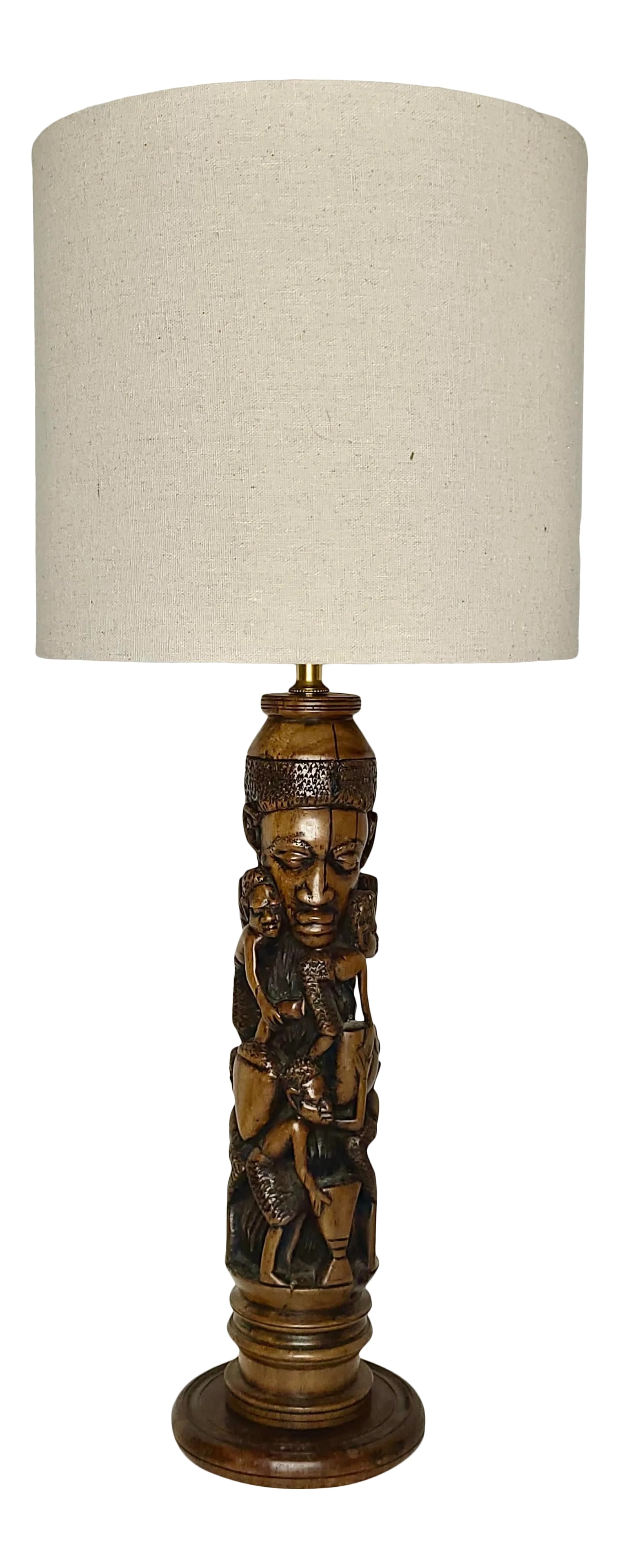 1920s African Hard Wood Carved Lamp with Intertwined Mother With Her Children Figurines: Masterful carving and a tender scene make this lamp really special. From the early 20th century, lamp has been rewired with modern electrics for safety. The lamp stands approximately 24" tall with a 1