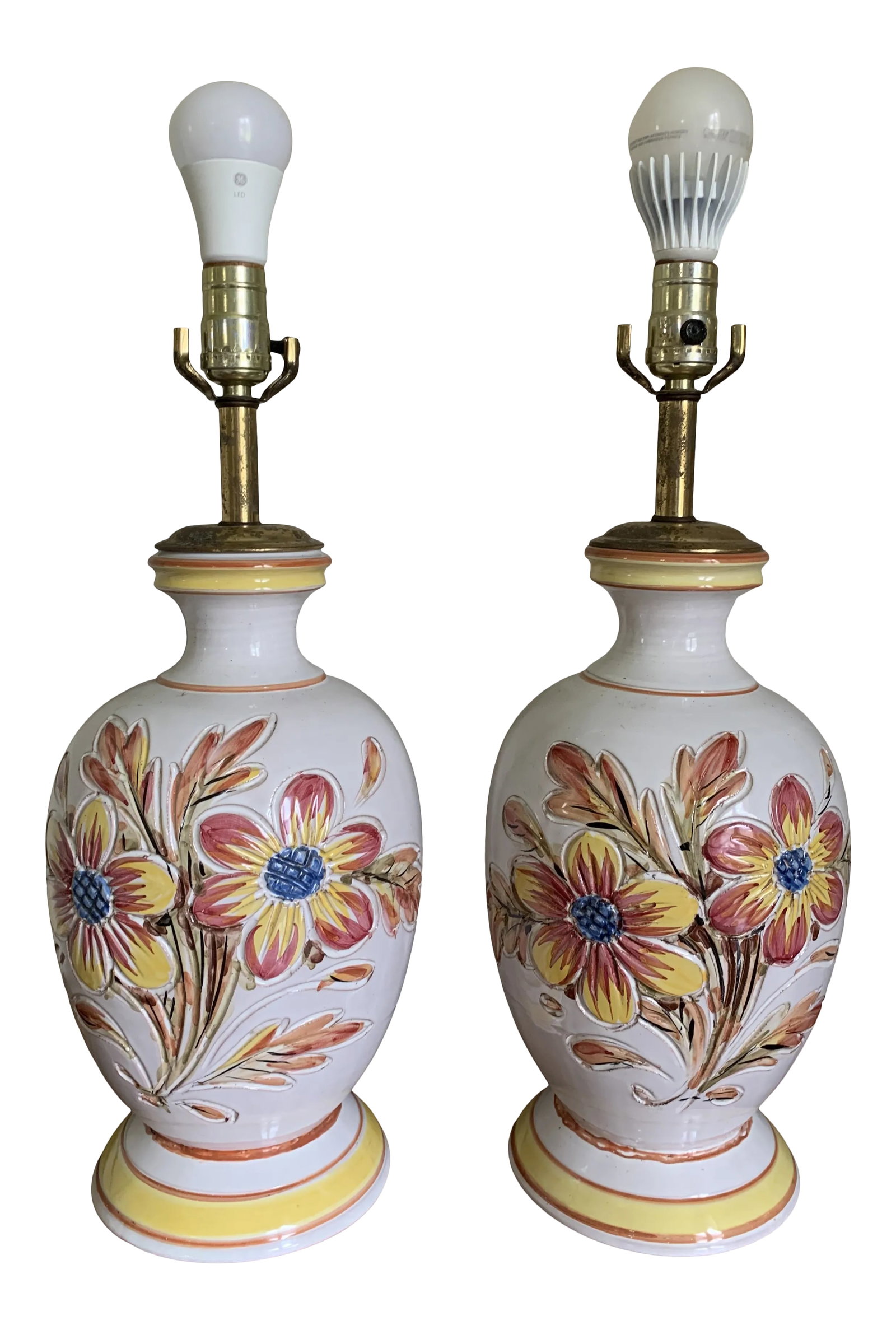 1980s Italian Ceramic Table Lamps With Flower Design - a Pair: Vintage original Italian pottery table lamps. They are in good working condition, in need of harps and shades. They have an etched flower design on red, yellow and blue. They measure 18.5" from table