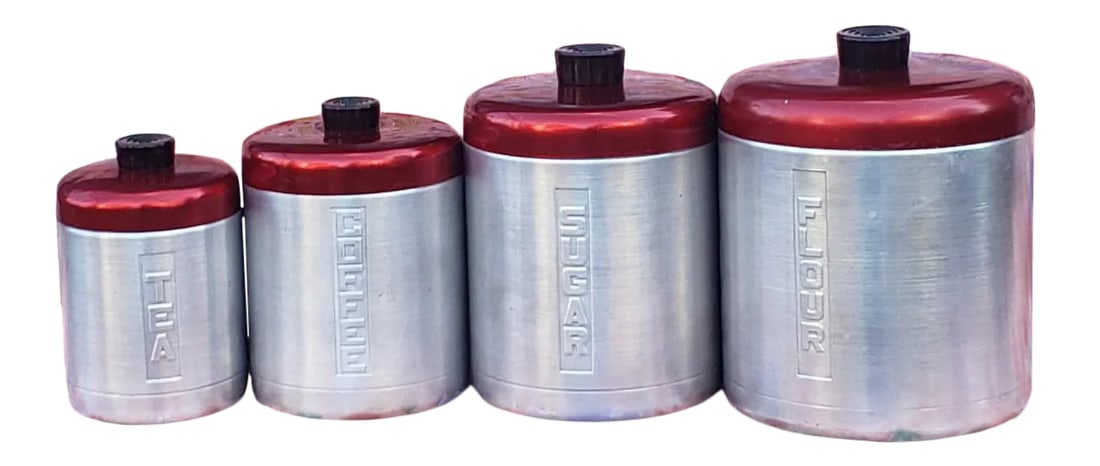 Vintage 1950s Century Aluminum Kitchen Canisters - Set of 4: Vintage 1950s Century brand nesting, spun aluminum, kitchen cannisters with rare "cranberry" colored red spun aluminum lids with bakelite handles. This is a set of four cannisters, with, in order of
