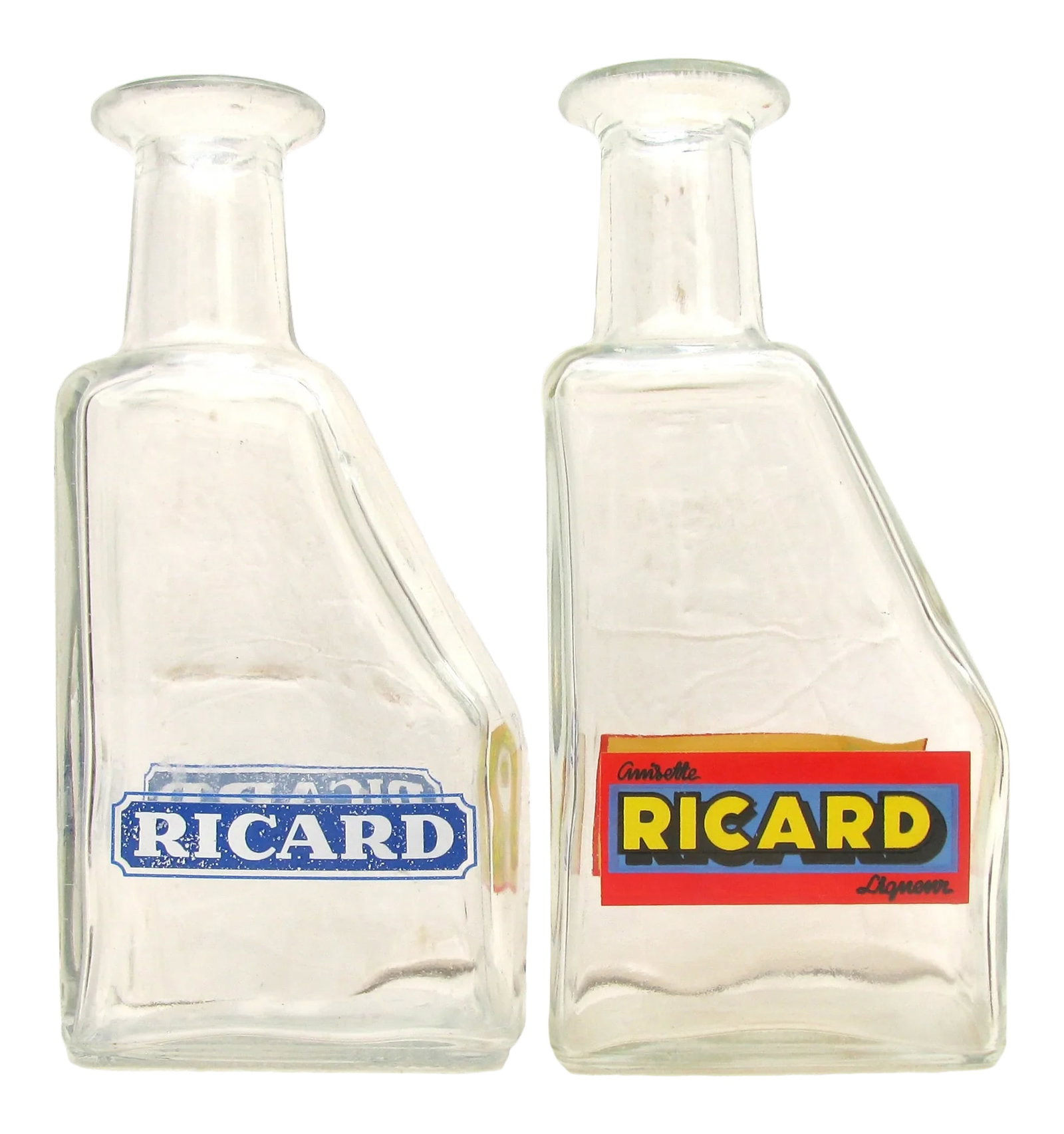 Midcentury French Bistro Carafes, Pair: Pair of traditional wedge shaped, French Bistro carafes sourced at an antique market in Provence. Created of heavy and sturdy glass and graphically appealing, they are great for mixers at the bar,