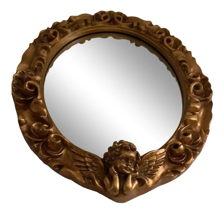 Mid 20th Century Small French Italian Gold Relief Mirror: Vintage French Italian Relief Gold Mirror With cherub Putti Angel holding his head in his arms Great small size for that one special spot in your wall Condition: Alterations: Unknown Imperfections: