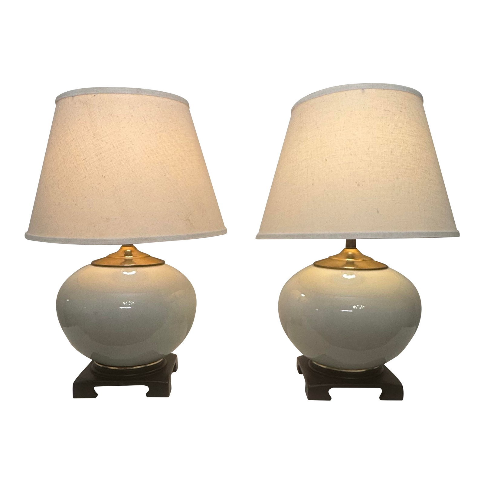 Vintage Transitional White Crackled Glaze Glass & Brass Table Lamps, a Pair: There's a transitional classic minimalism along with subtle Asian inspiration to this pair of table lamps. Each lamp consists of a white crackle glazed glass round base sandwiched by satin brass top