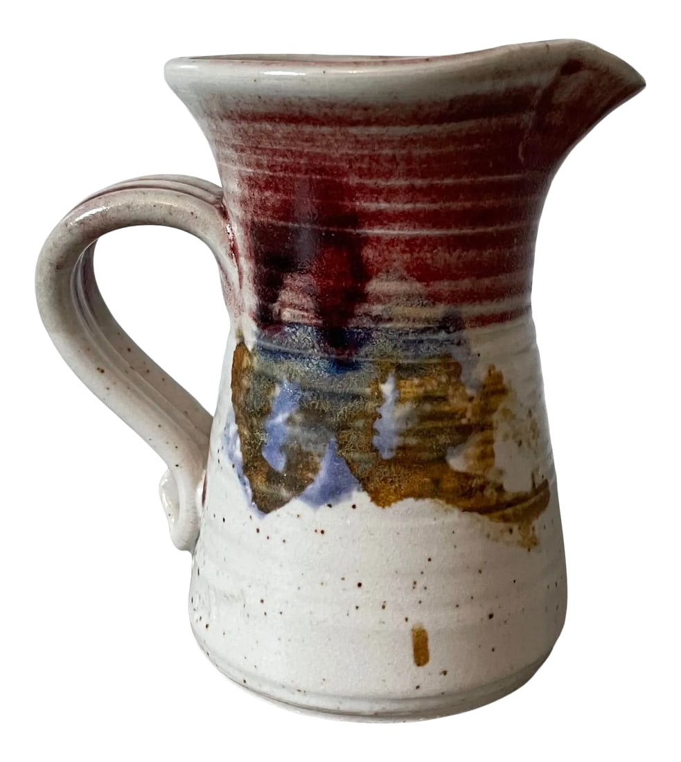 Vintage Hand-Thrown Artist Signed Studio Pottery Glazed Small Pitcher: Very cool hand made light gray speckled pitcher with blue, cranberry, and goldenrod accent. Unique and sturdy handle to pour. Bottom has protector pads and the artist's signature. MEASUREMENTS Height: