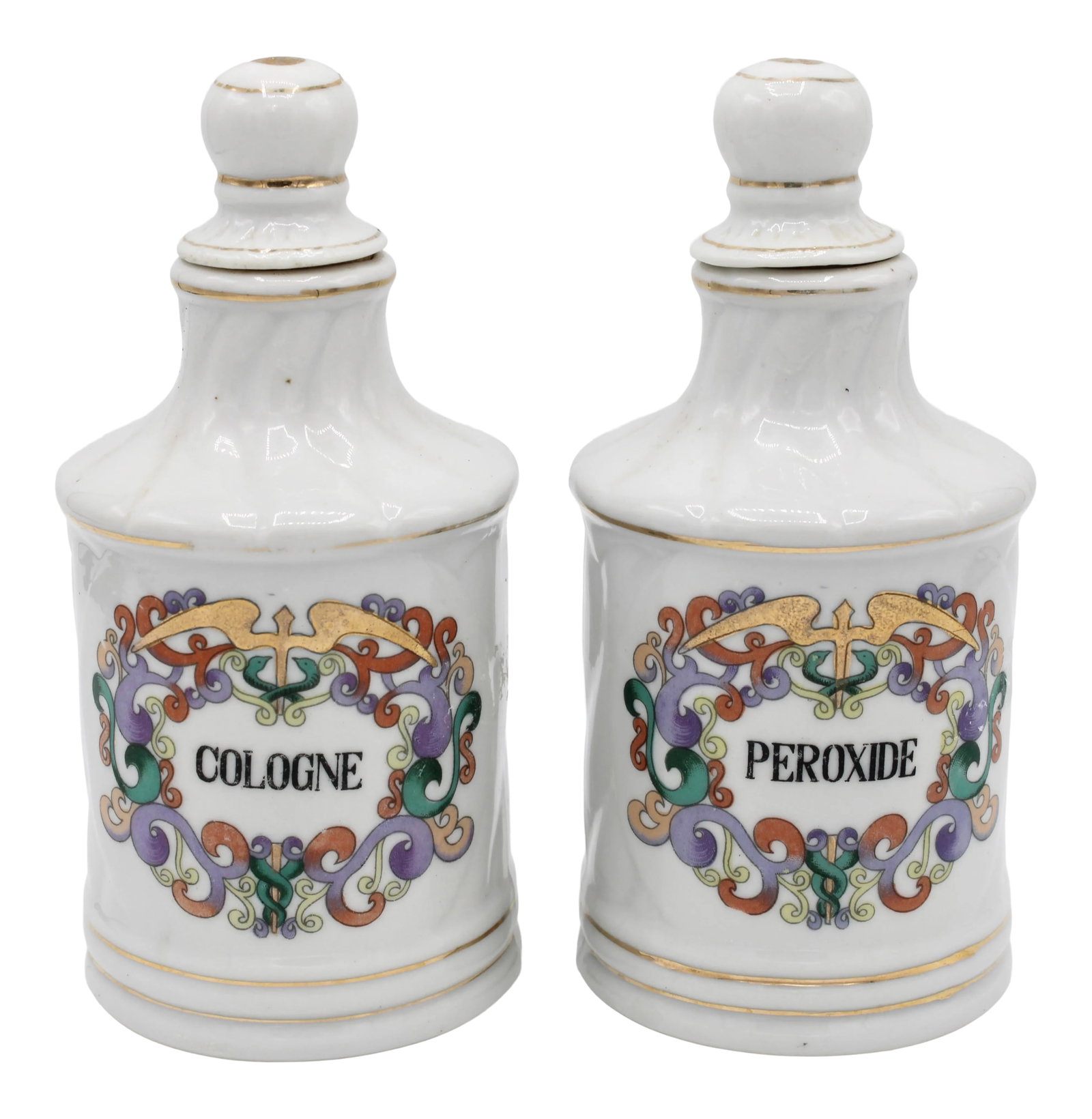 Antique French Ceramic Apothecary Jars - a Pair: An exquisite pair of rare Antique French Apothecary Jars labeled Cologne and Peroxide, circa 1910. These are a sophisticated pair with the Greek messenger God, Hermes, symbol that is a common medical