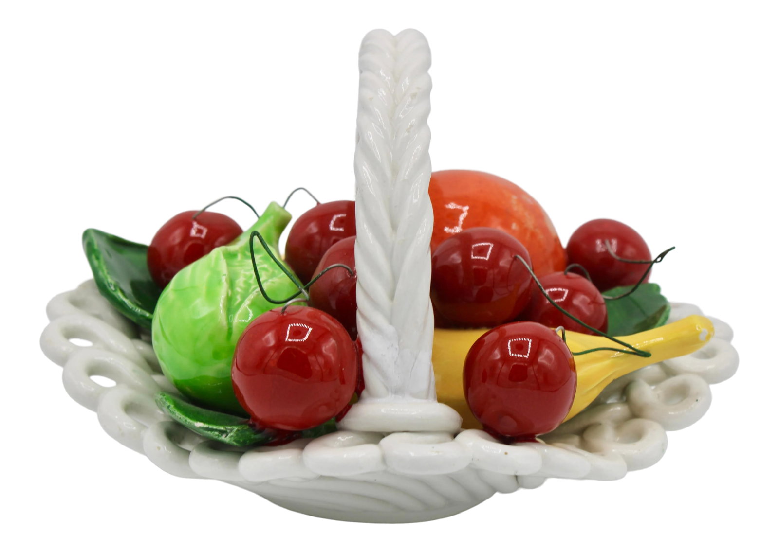 Mid Century Italian Ceramic Fruit Basket: A charming mid 20th century Italian ceramic fruit basket. Cherries, oranges, a banana, and a lime green vegetable fill this woven patterned white Italian fruit basket. Condition: Alterations: