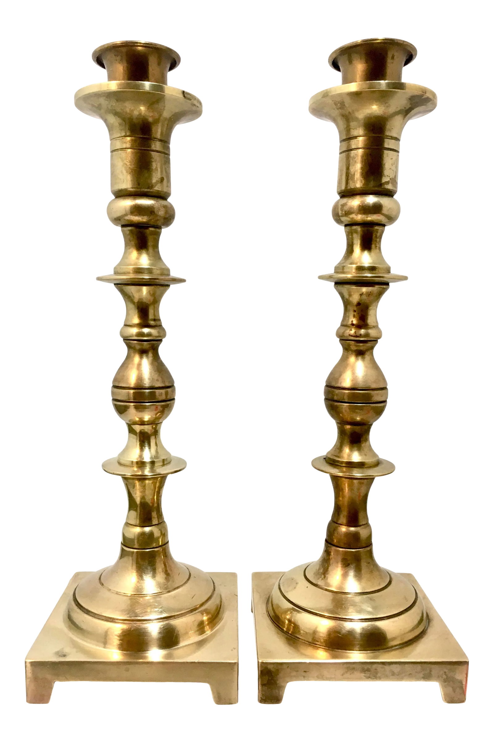 Pair of Solid Brass Candlesticks + Candle Followers: Solid brass and nicely turned, these two candlesticks have a warm, golden patina. Includes two candle chasers. Dimensions: 3.425" x 3.425" x 10.25" (overall) 9.5" (Base to top of drip plate) 1.625" x