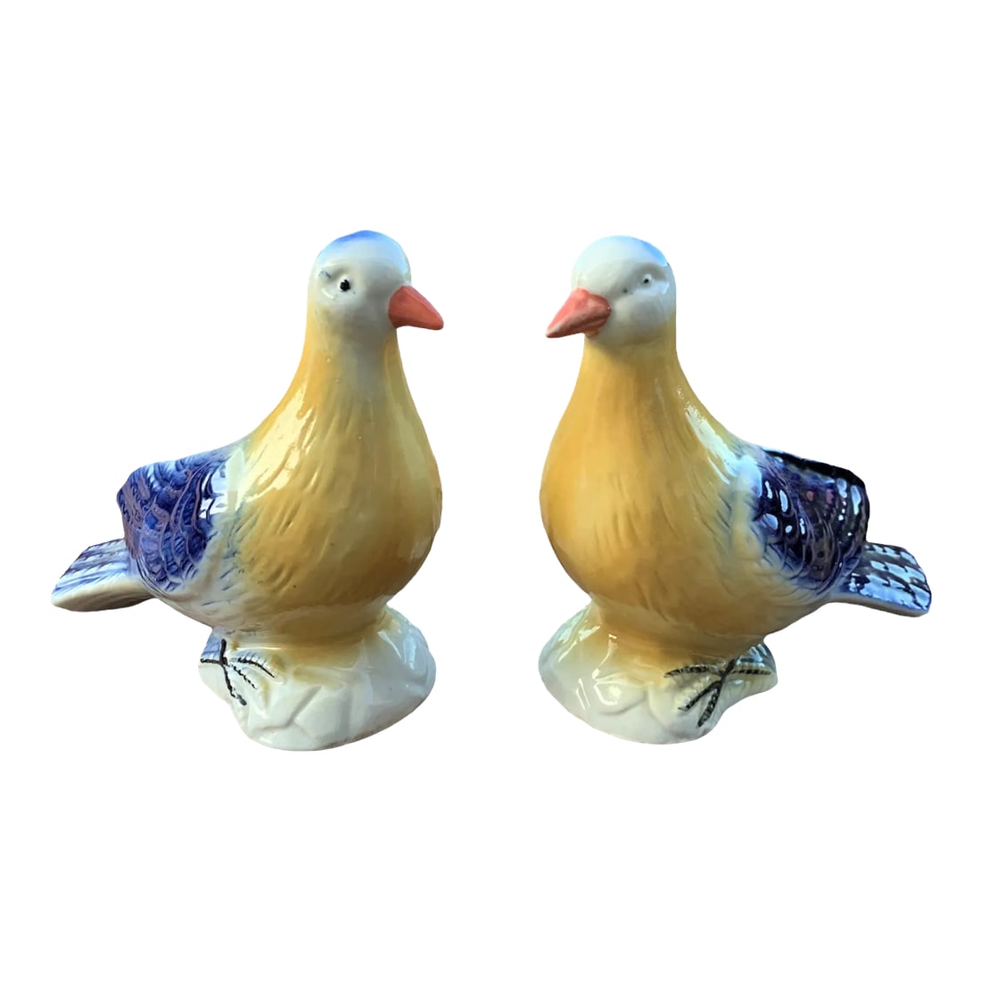 Late 20th Century Brazilian Porcelain Blue & Yellow Bird Figurines- a Pair: Pair of blue & yellow bird figurines hand-painted and made in Brazil. The colors are stunning on these two doves and the painted feet are intricate. A very nice set for the collector or as a room
