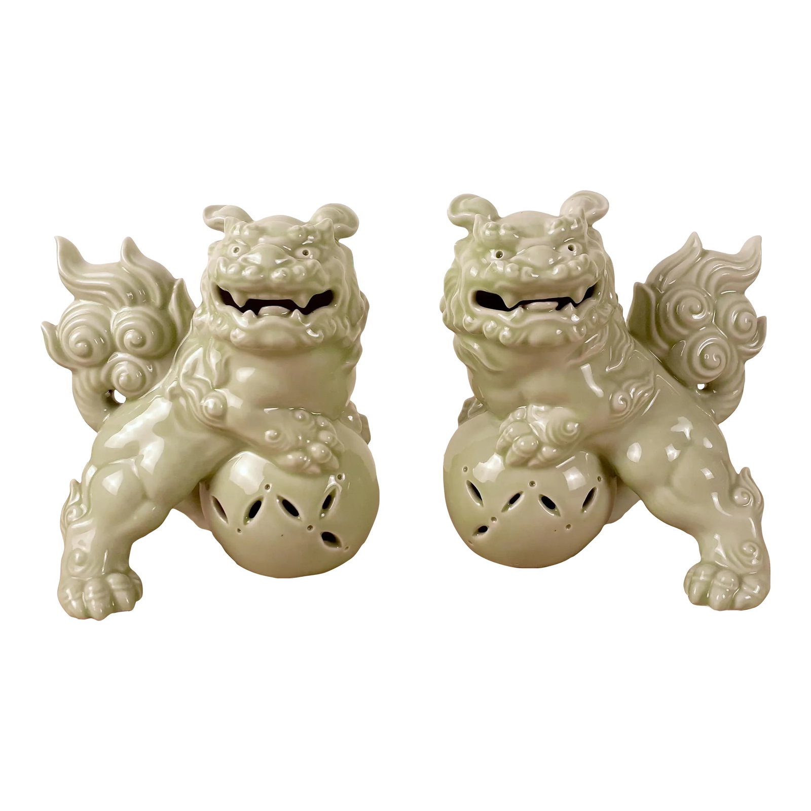 Mid Century Pair of Chinese Celadon Fu Dogs: A pair of vintage Chinese celadon Fu Dogs with a rare, delicate celadon glaze, unglazed base. Circa ROC, no later than mid century. size each piece: 7 1/2" high x 6 3/4" wide x 5 1/4" deep Condition: