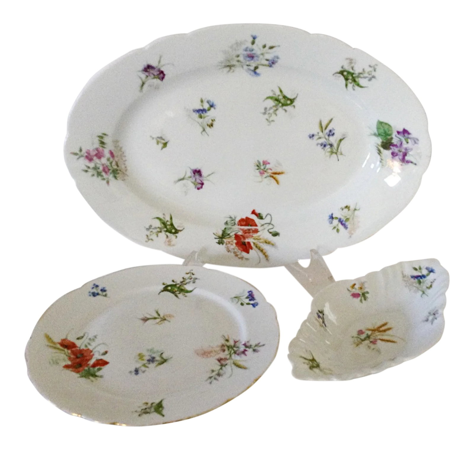 French Spring Wildflower Serving Pieces - Set of 3: Set includes a large platter, vegetable side dish and a raised cake plate each decorated with scattered spring flowers. The platter and side dish each have a small chip on the underside of the rim. Pl