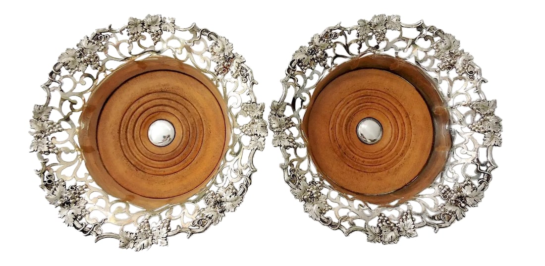 Fine Antique Victorian English Silver Plate Reticulated Wine or Champagne Bottle Coasters - A Pair: A pair of classic late Victorian high quality silver plated wine or champagne bottle coasters. The delicate rims are beautifully cast with a pierced or reticulated grapevine and leaf decoration. The c