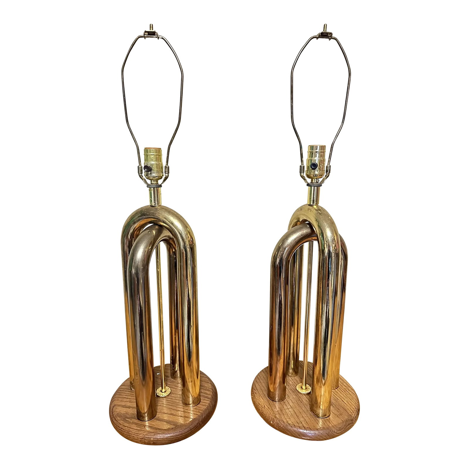 1970s American Modernist Table Lamp Pair Brass and Walnut: Clever in their simplistic form, brass plated arches mounted to simple walnut discs. Tall and striking. Offered without shades. 20 tall without wands, 29" tall with 9" wands. Base is 9" wide. Blends