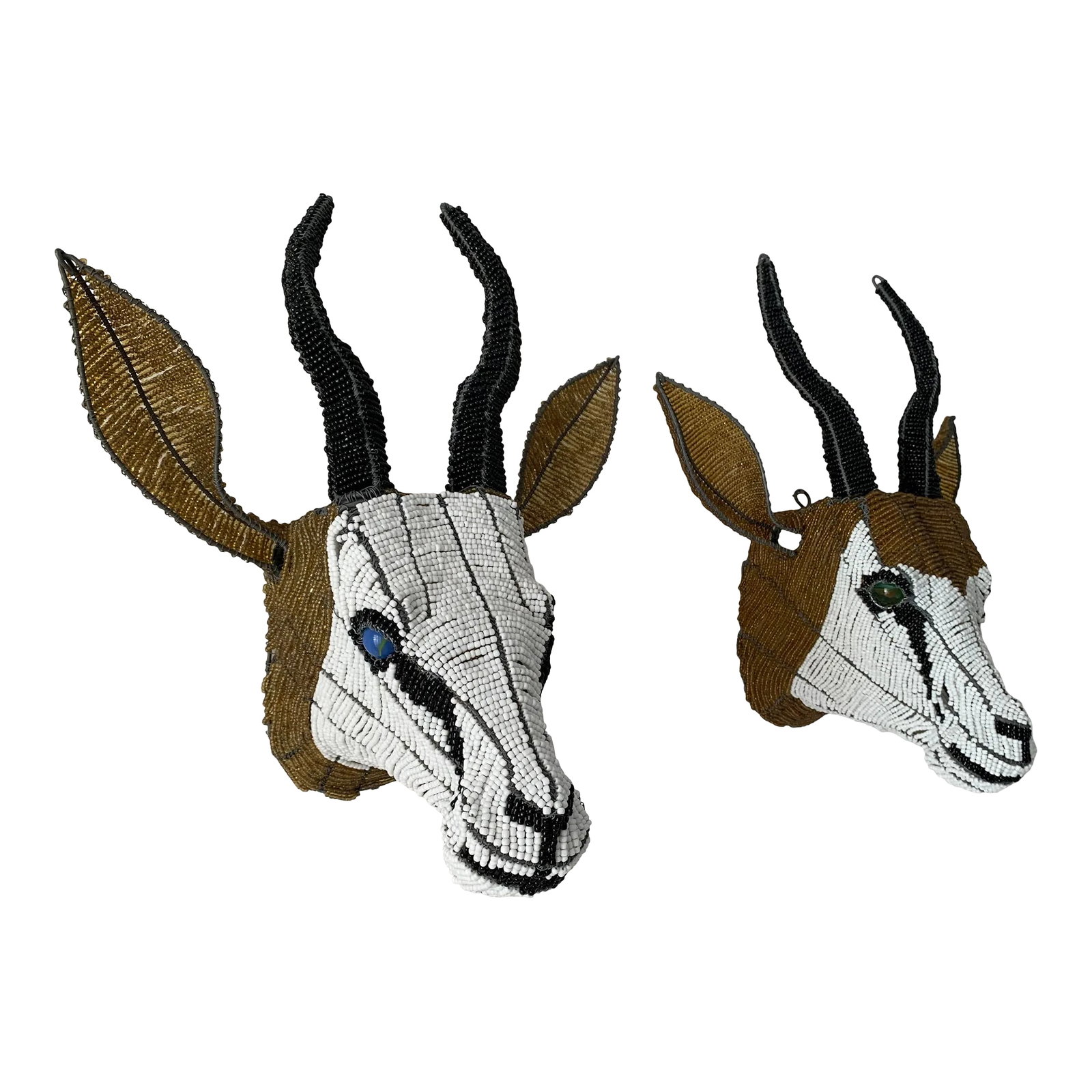 Late 20th Century Pair of Beaded Antelope Springbok Wall Mounts: Pair of Sprinbok beadaed antelope heads. Beautiful glass beads strung on wires with a wire frame for support of the structure. One has green glass marble size eyes and the other blue.The Springbok is