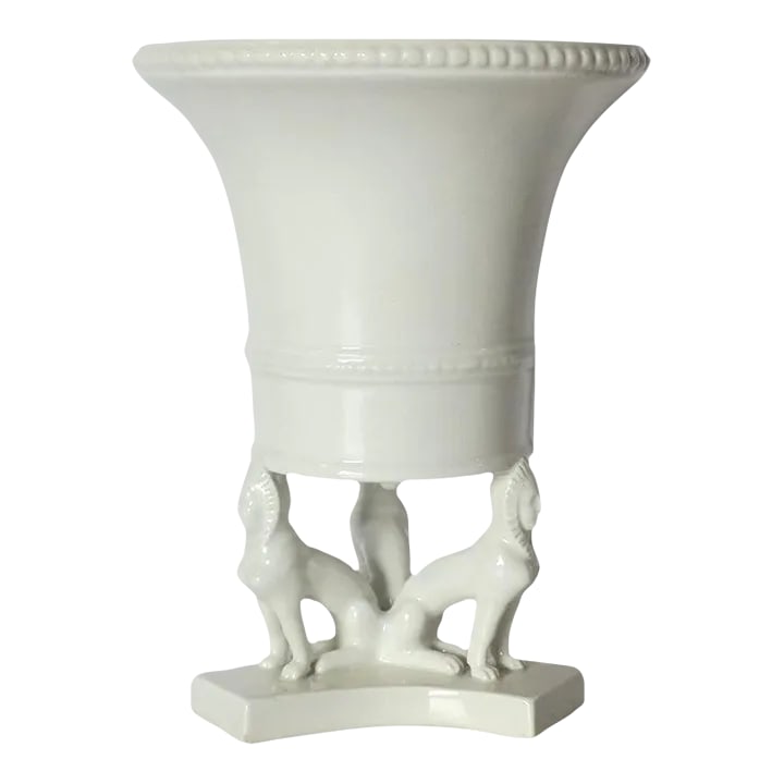 Italian Urn Vase Planter With Dogs Egyptian Revival Style: A white Italian ceramic urn vase or cachepot planter in the Egyptian Revival style, circa late-20th century, Italy. A white urn vase or cachepot (flower or plant planter) with three Egyptian Pharaoh d