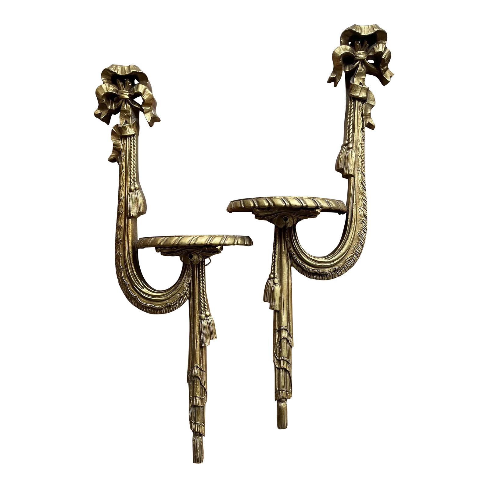 Pair of Vintage French Style Giltwood Display Shelf: Fabulous pair of vintage gilt-wood wall bracket display brackets. Just the right amount of carved details in mint condition gilt finish. A flowing ribbon bow, tassels and ropes, scalloped detail with