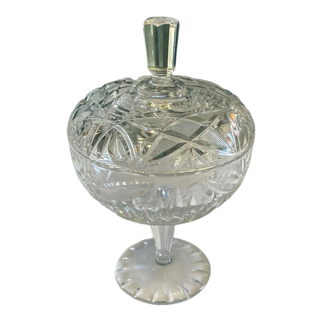 Mid-Century Glass Pedestal Candy Dish With Lid: This vintage cut crystal pedestal candy dish features a classic silhouette with detailed geometric cuts and a faceted finial lid. The elevated base adds elegance, making it both functional and decorat