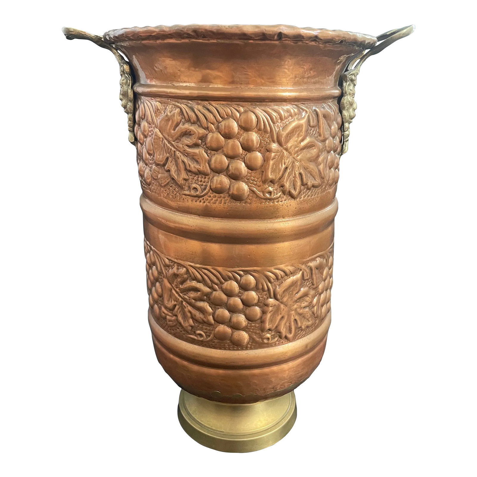 Vintage Embossed Brass Grapes & Vines Jardiniere Planter Vase With Lion Head Handles: A lovely vintage brass vase planter. Features hammered grapes and vines motifs wrapping around the copper finished body. Accented with duo lion head handles. Nice condition with slight overall