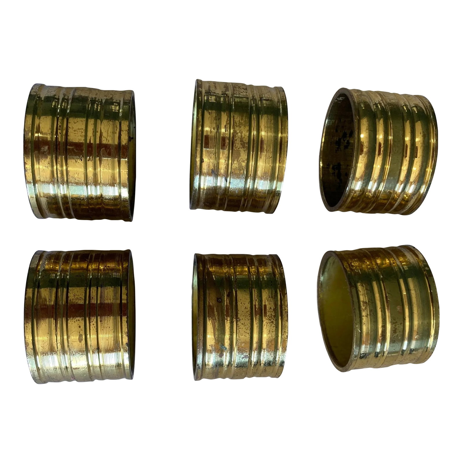 1960's Solid Brass Napkin Rings- Set of 6: Add timeless elegance to your dining presentation with this set of six vintage ribbed brass napkin rings. The grooved design and warm golden patina make these pieces a perfect accent for both casual a