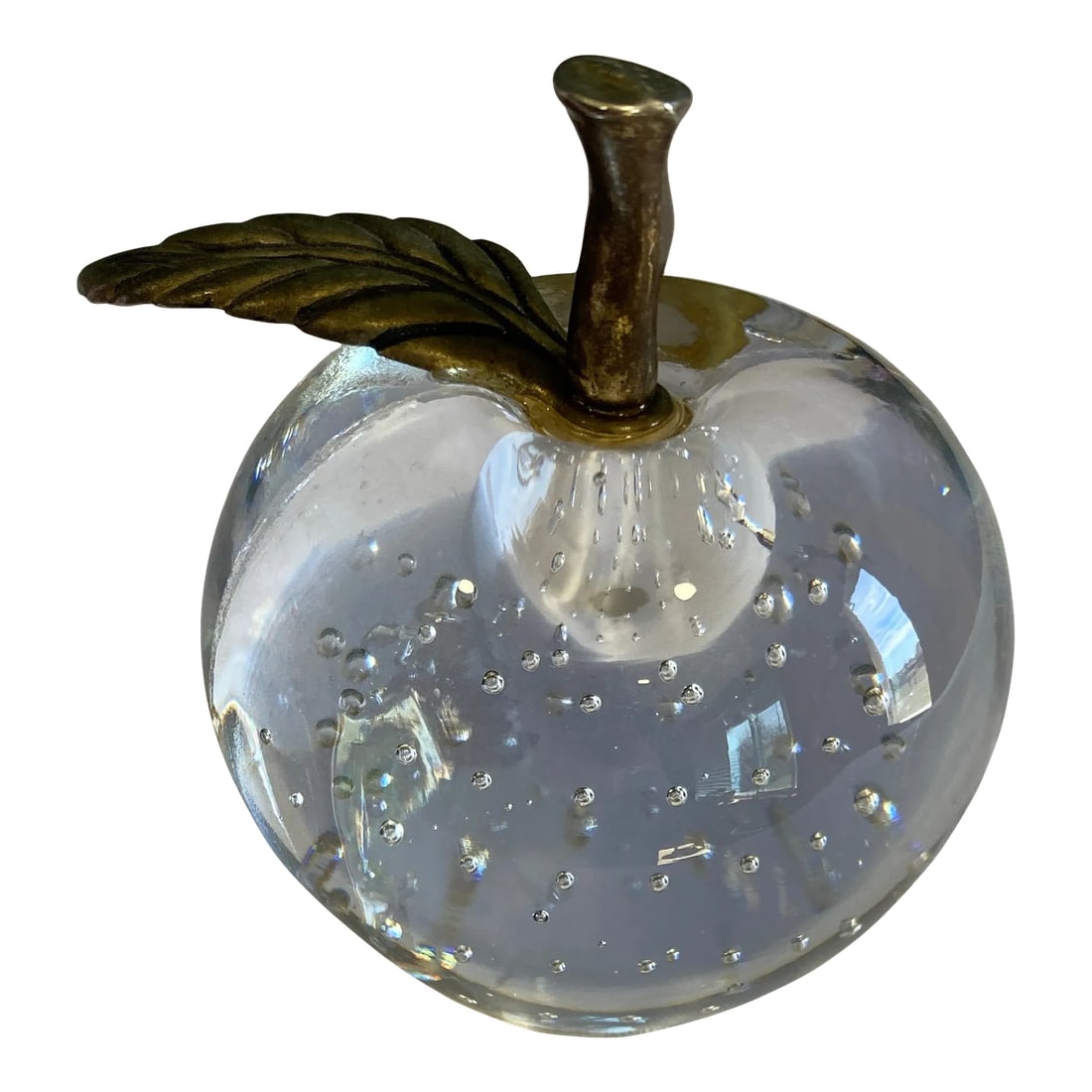 Vintage Glass Apple With Brass Leaves: A classic vintage crystal apple paperweight featuring clear glass with decorative bubble inclusions and a brass stem with sculpted leaf detail. The apple form catches light beautifully, creating soft 