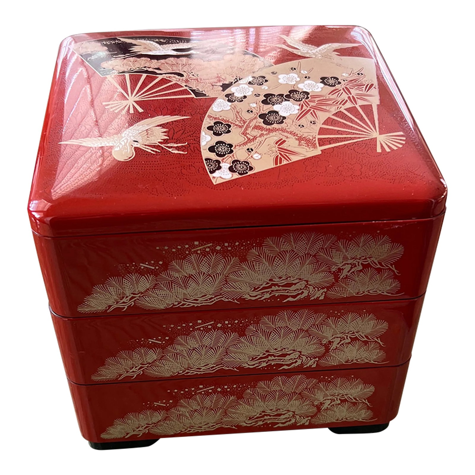 Late 20th Century Yamanaka Japanese Red Lacquer Ware 3 Tiered Stacking Bento Box: Wonderfully detailed red lacquerware plastic stackable Japanese bento box. This Yamanaka box is beautifully detailed with gold feathers around the sides and black, white and gold fans, cranes and flow
