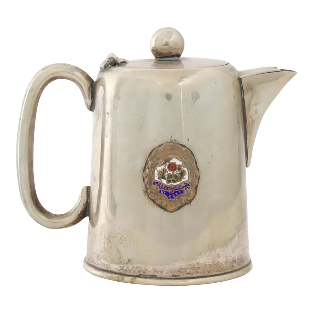 Early 1900s English Masonic Lodge Hot Water Pot: This English silver-plated hot water pot, adorned with a Masonic Lodge emblem, is a piece rich in ceremonial significance. Ideal for collectors of Masonic items or those who appreciate the allure of f