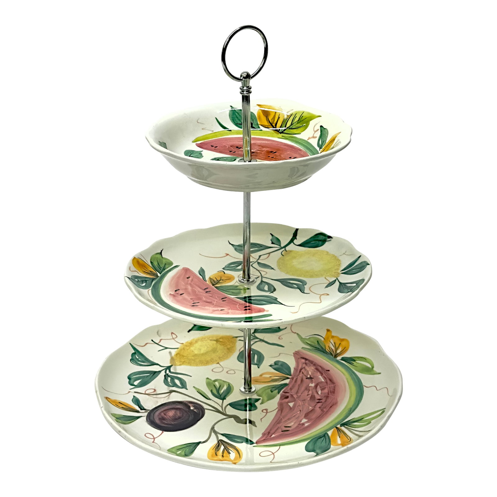 Whimsical Hand-Painted 3-Tier Ceramic Cake Stand: White fruit motif ceramic cake stand. This mid-century piece is a white ceramic cake stand with three-tiers, featuring a hand-painted fruit motif design. Made in Italy. Height: 13.5" Width: 10.25" Con