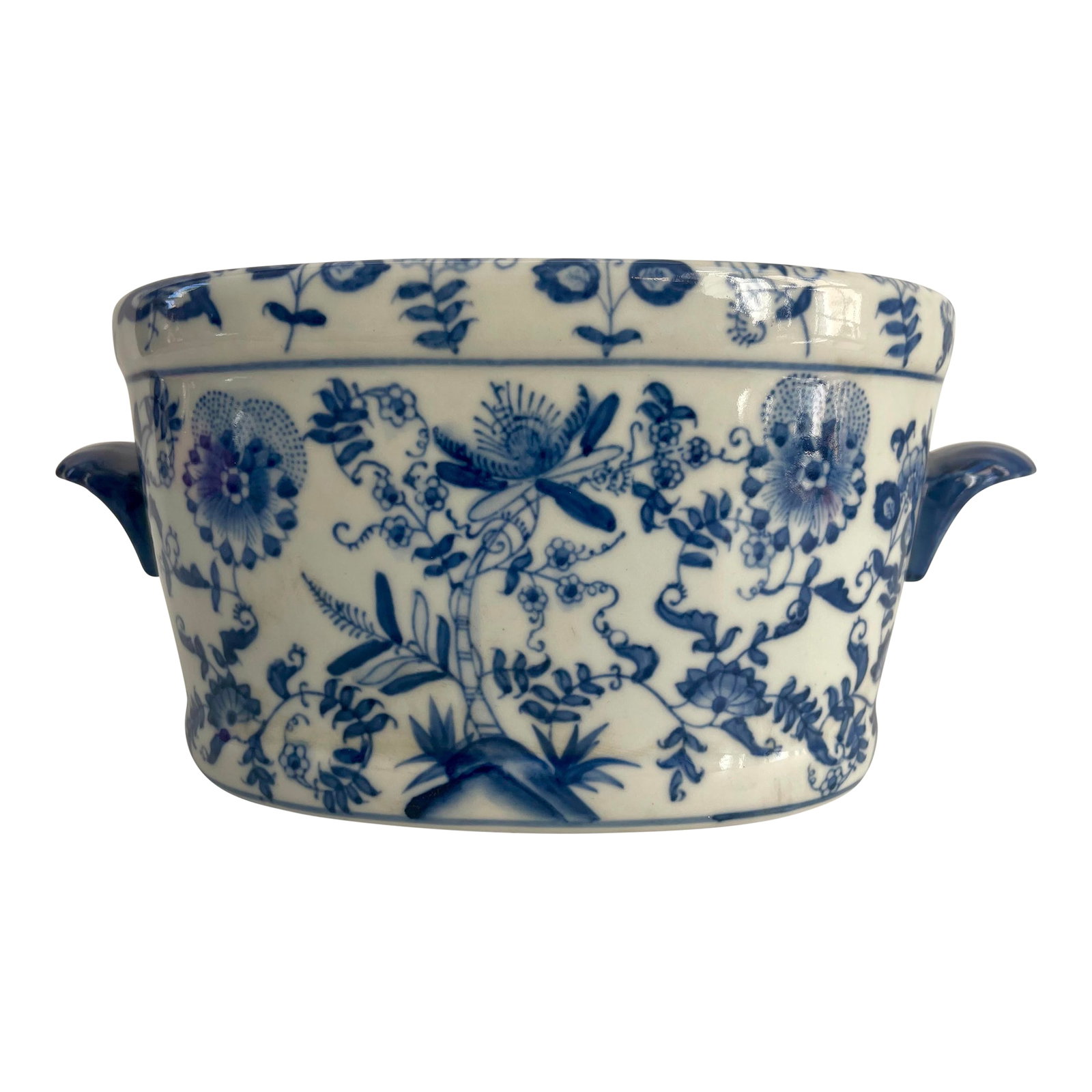 Chinese Export Style Porcelain Jardiniere Oval Bowl: A delightful Chinese export style porcelain jardiniere with double handles flanking an oval form with thick form rim in blue and antique white. The body exterior is finely decorated with ornate blue
