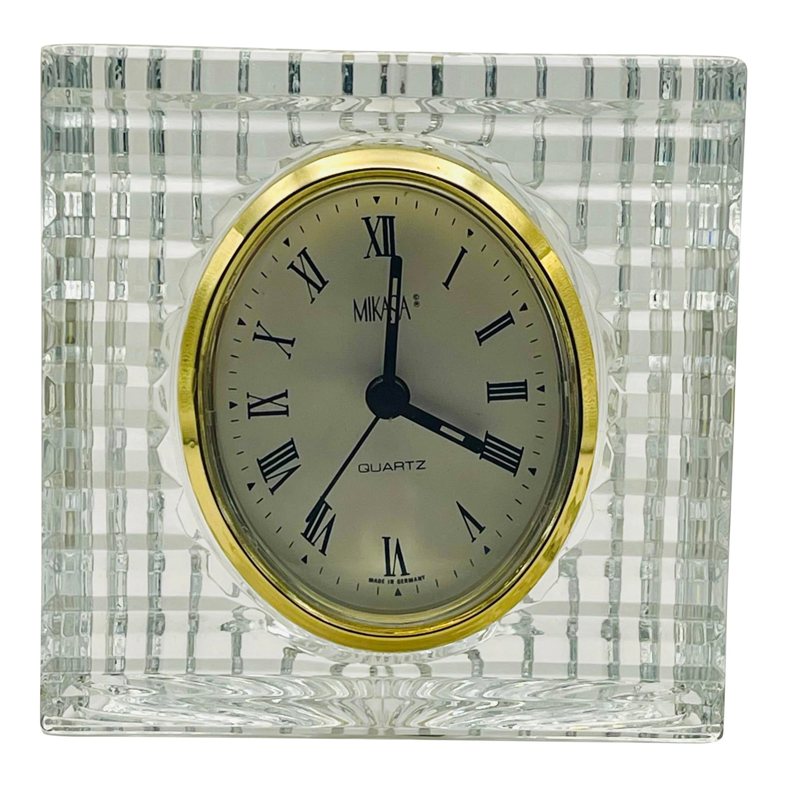 1990's Mikasa Optic Crystal Clock: A late 20th century fluted glass desk clock with a gold colored frame and Roman numerals. Chairish sells clocks only with display as the intended use. The mechanical elements are not guaranteed to be 