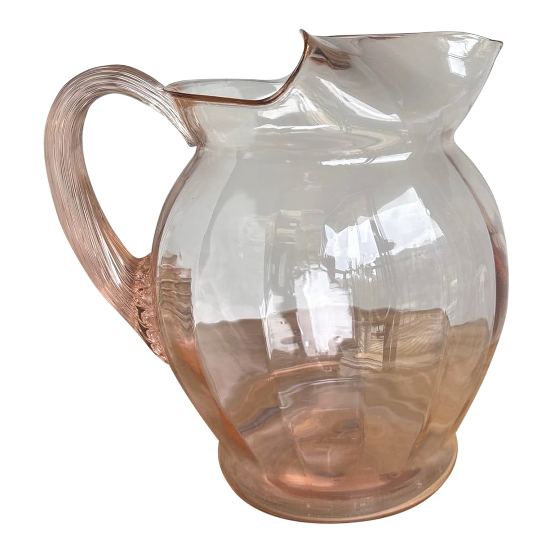 Macbeth Evan's Pink Depression Glass 1930's Pitcher: The product is an American Sweetheart MacBeth-Evans pitcher from the 1930s, made of pink glass with a capacity of 80 oz. This antique pitcher is a lovely example of pressed glass with a glossy