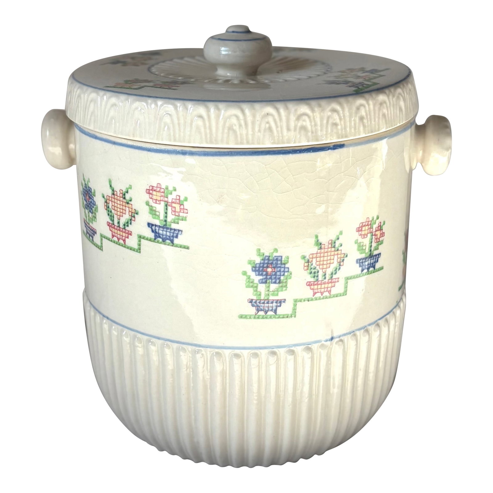 1940's Trompe L'oeil Needlepoint Japanese Ceramic Biscuit Jar: This charming ceramic biscuit jar features dimensional ribbing around its lower half , blue pin stripping, round ceramic handles, and trompe l'oeil needle point potted flower artwork on its upper half