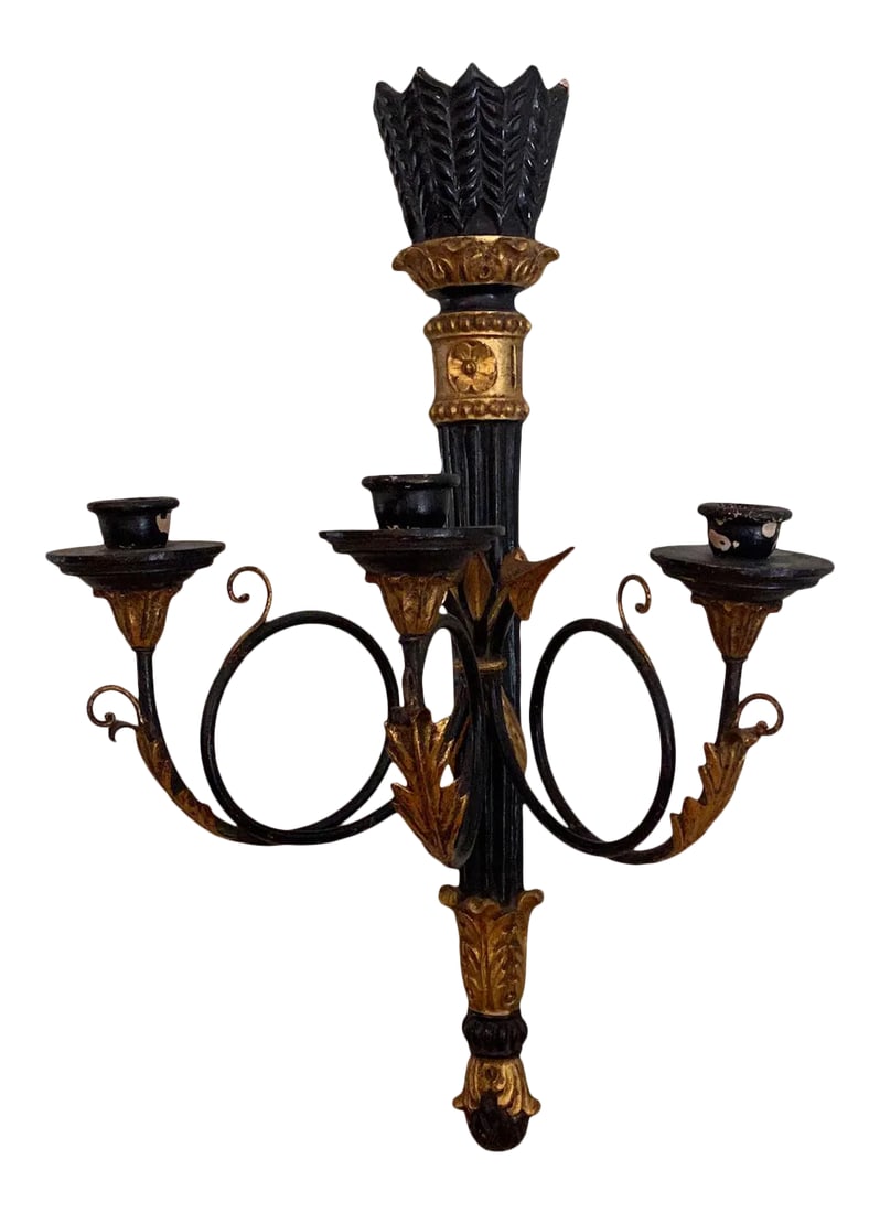 Vintage Gilt and Black 3 Taper Wall Sconce: Three taper wall sconce. Featuring a reeded ebonized wood column with decorative gilt accents. Three black metal arms with scrolled leaf design ending in taper holders. With intentional distressing.